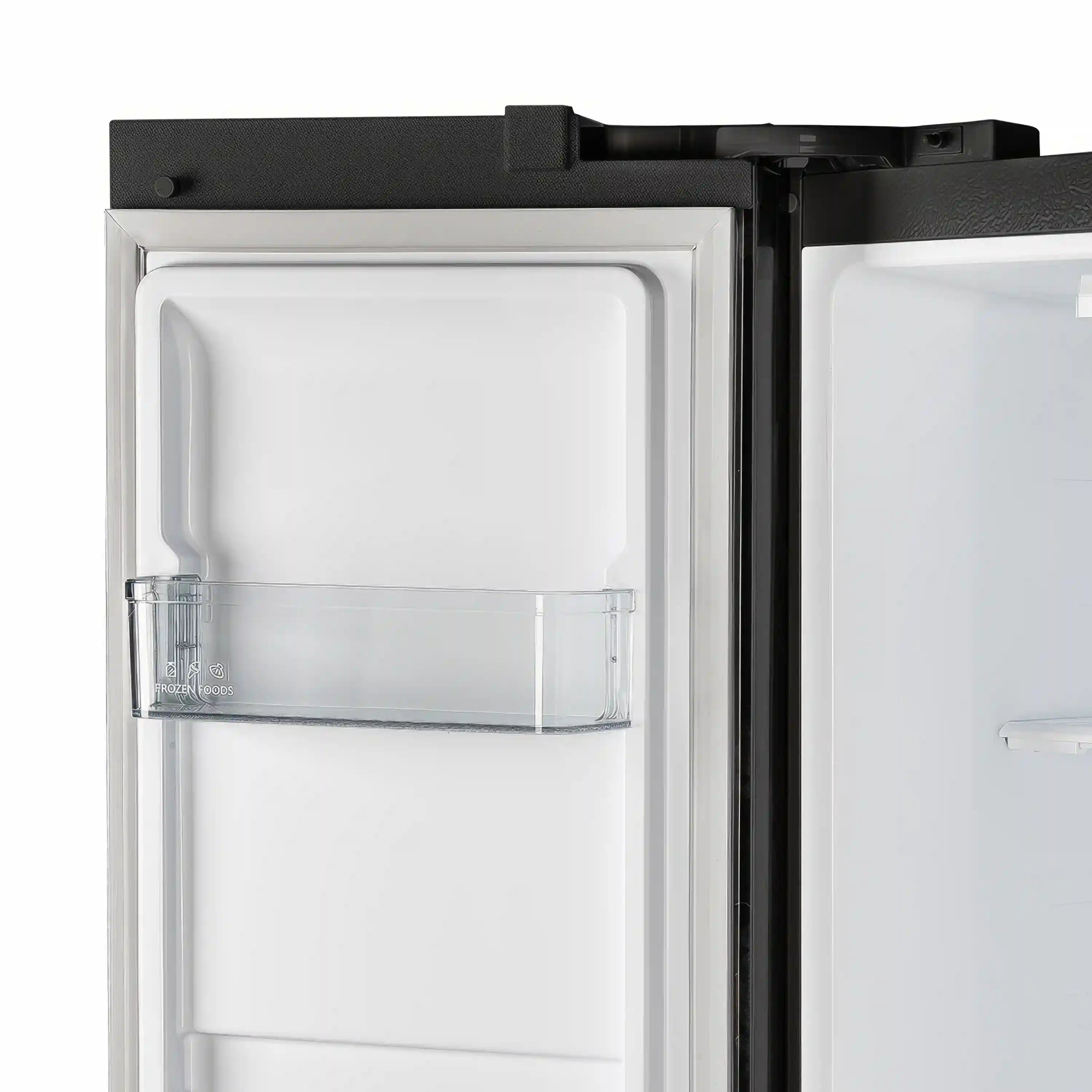 Refrigerator door open with clear shelf guard and white storage compartment