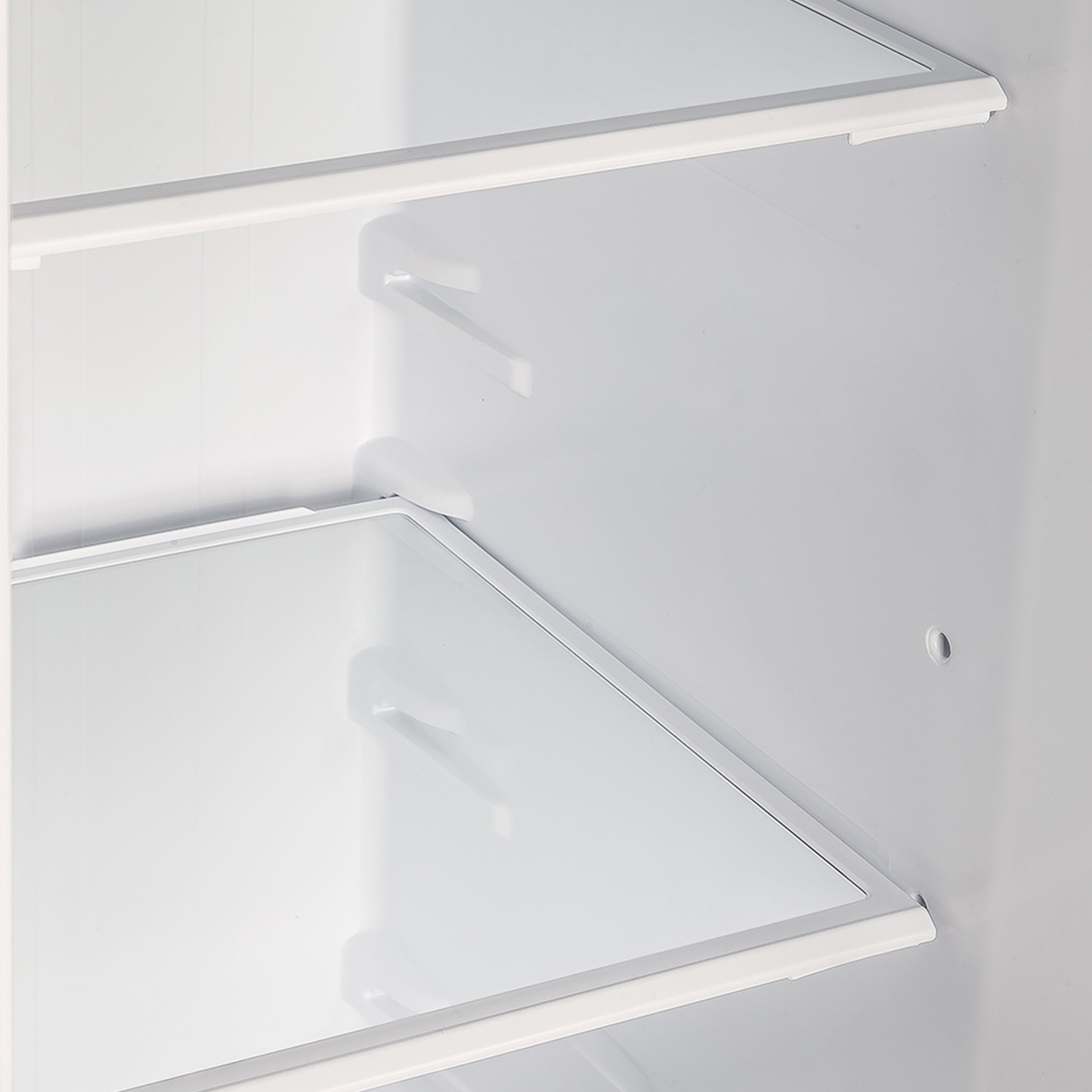Refrigerator interior with adjustable shelves and angled door storage