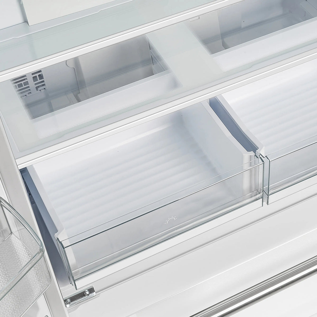 Bottom freezer drawer interior with storage bins in white French door refrigerator