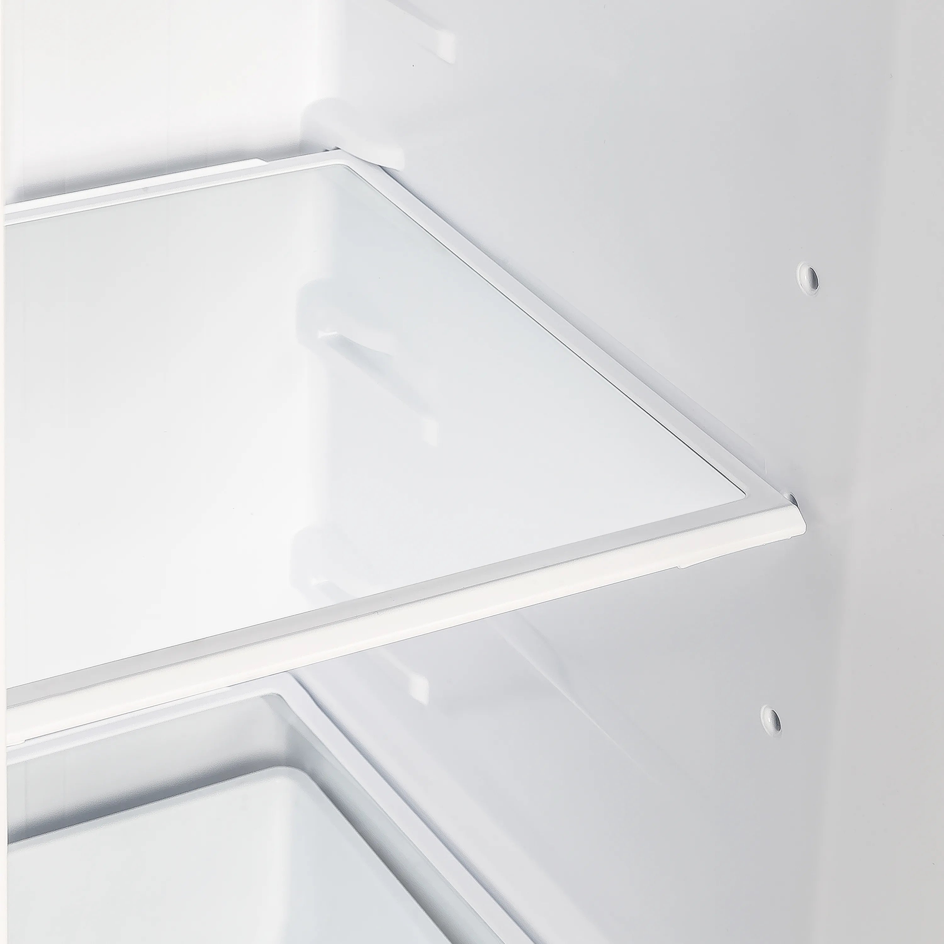 White freezer compartment interior with upper shelf and side wall panel