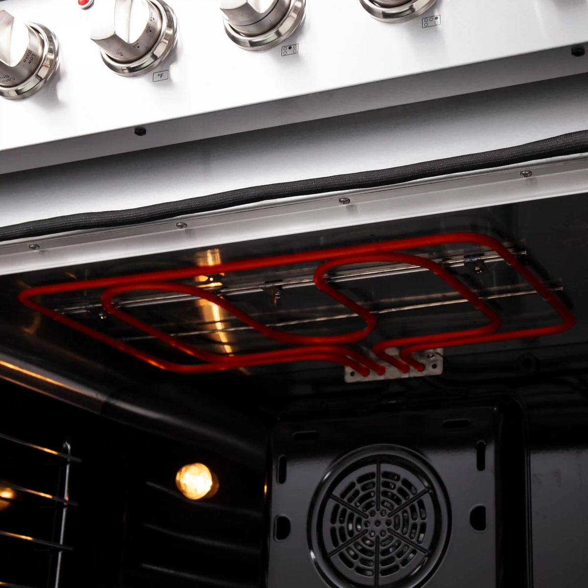 Stainless electric oven interior with red heating element and fan vent