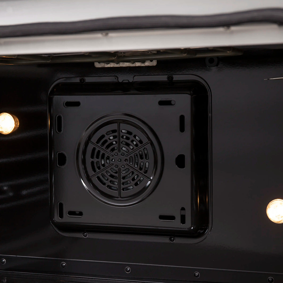 Close-up of convection oven fan housing in the bottom of the oven