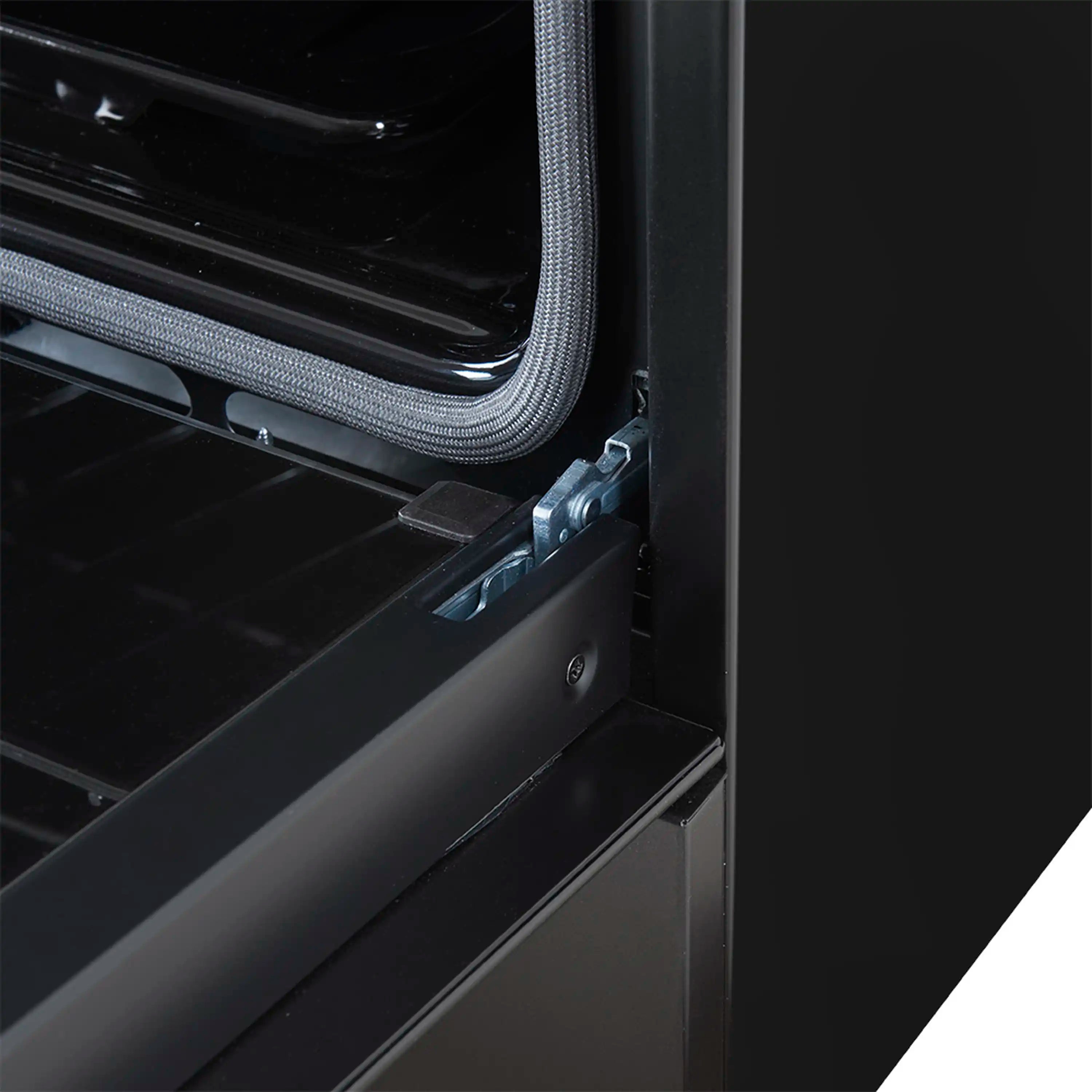 Black oven door area with flexible seal and hinge hardware at side