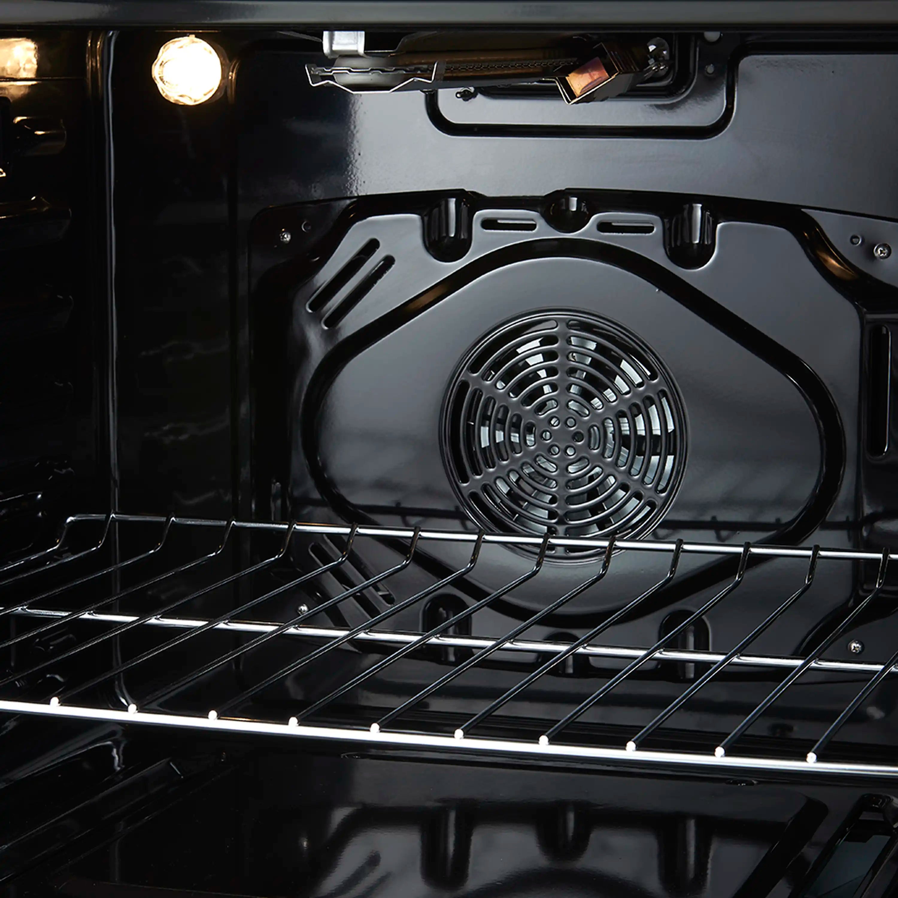 Black oven interior with circular fan and wire rack