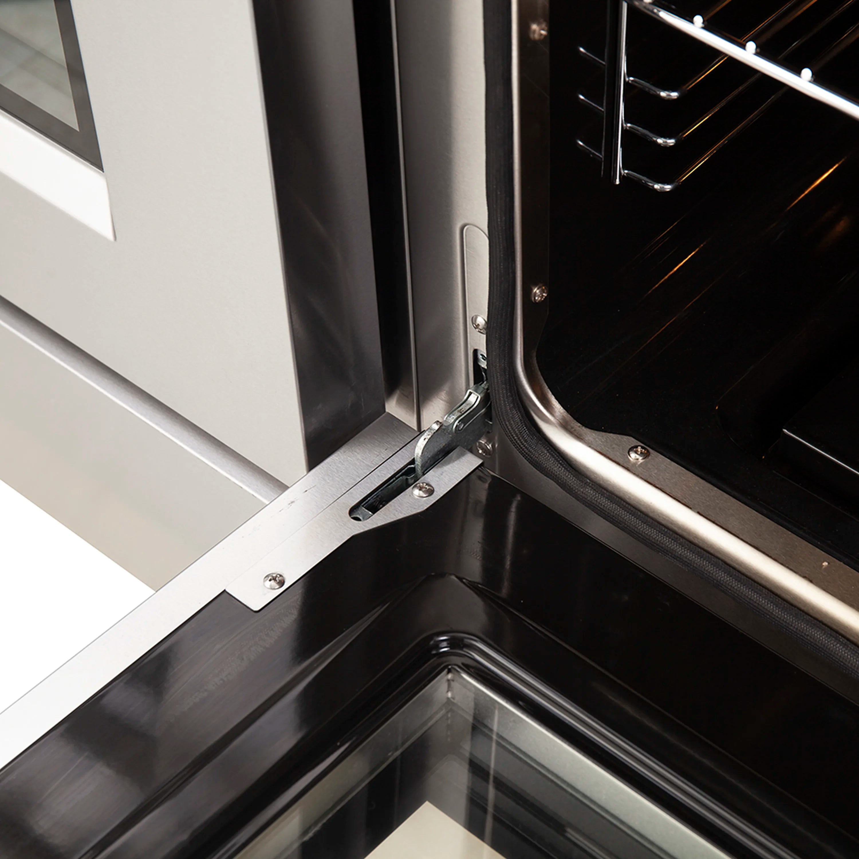 Gas oven range door hinge and latch inside a stainless steel oven