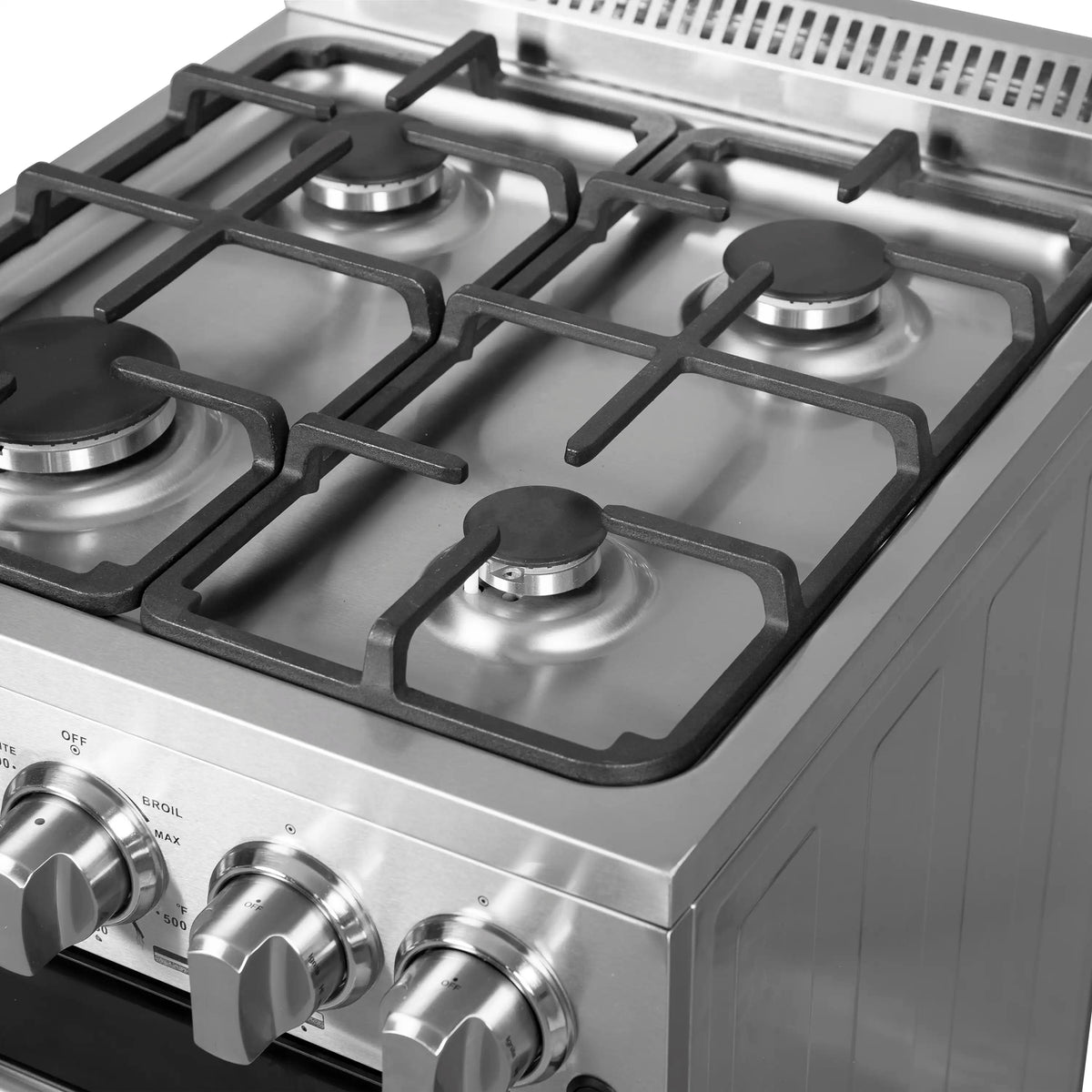 Close-up of stainless steel gas cooktop burners with black burner caps and grates
