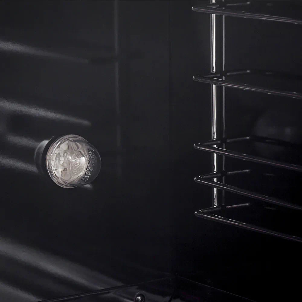 Gas range oven cavity view with glowing burner and black enamel back wall