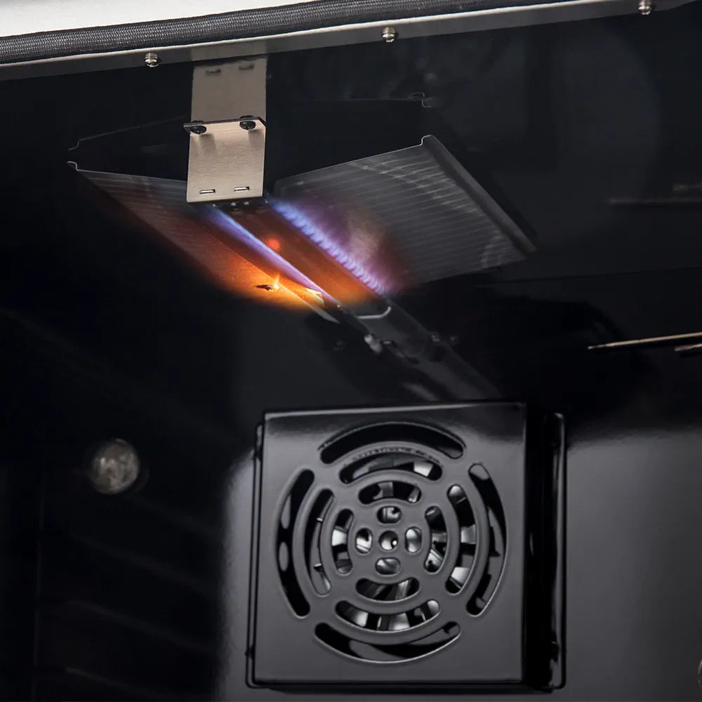 Gas range oven burner flame and vent plate in stainless cavity