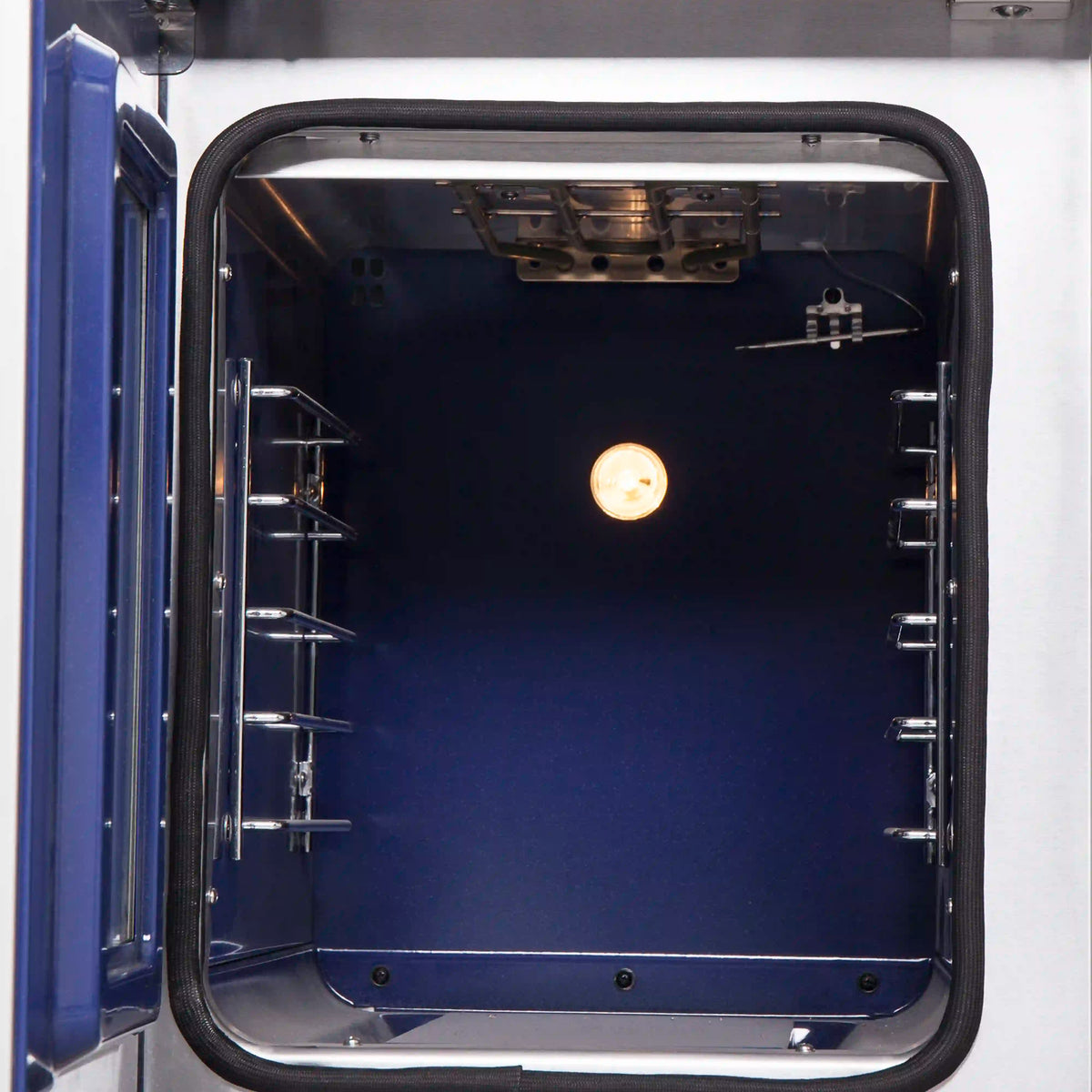 French-door oven interior with broil/bake rack and glowing oven light