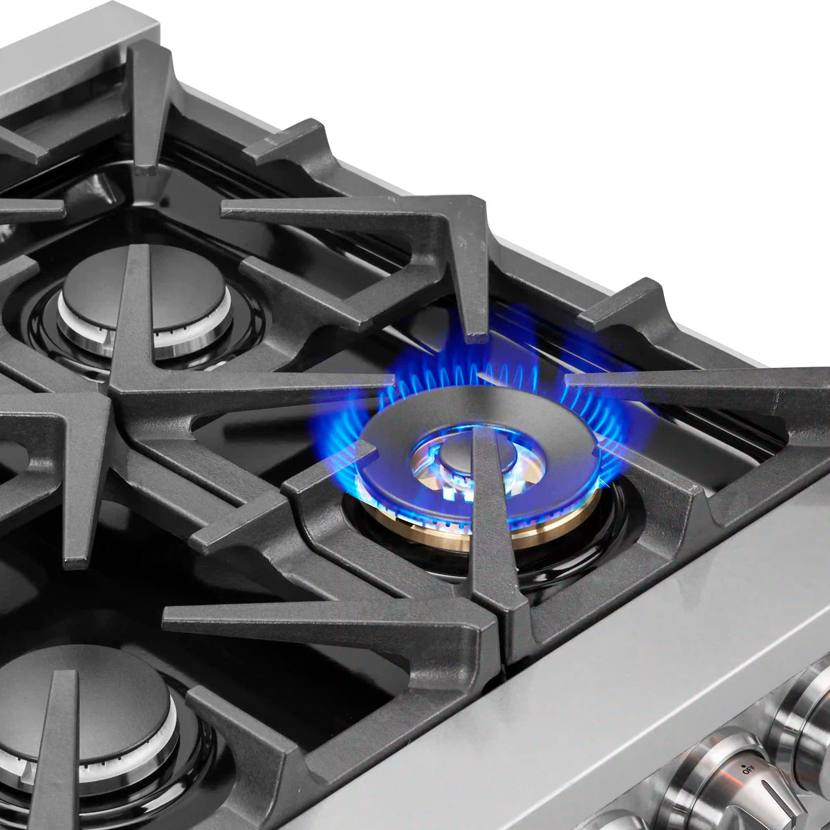 Gas burner with blue flame under cast-iron grate on stainless cooktop.