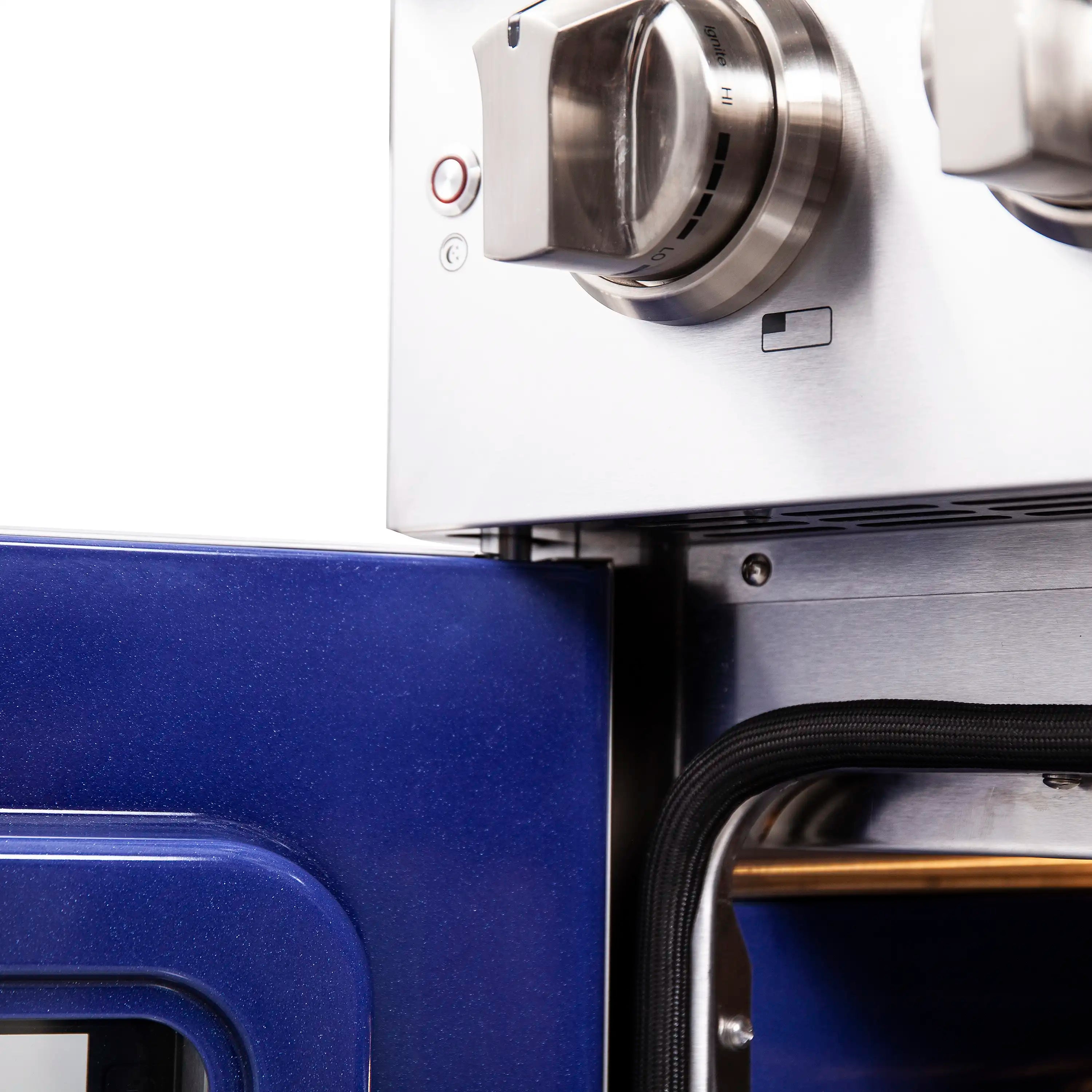 Stainless steel control knob panel next to the oven opening on a gas range