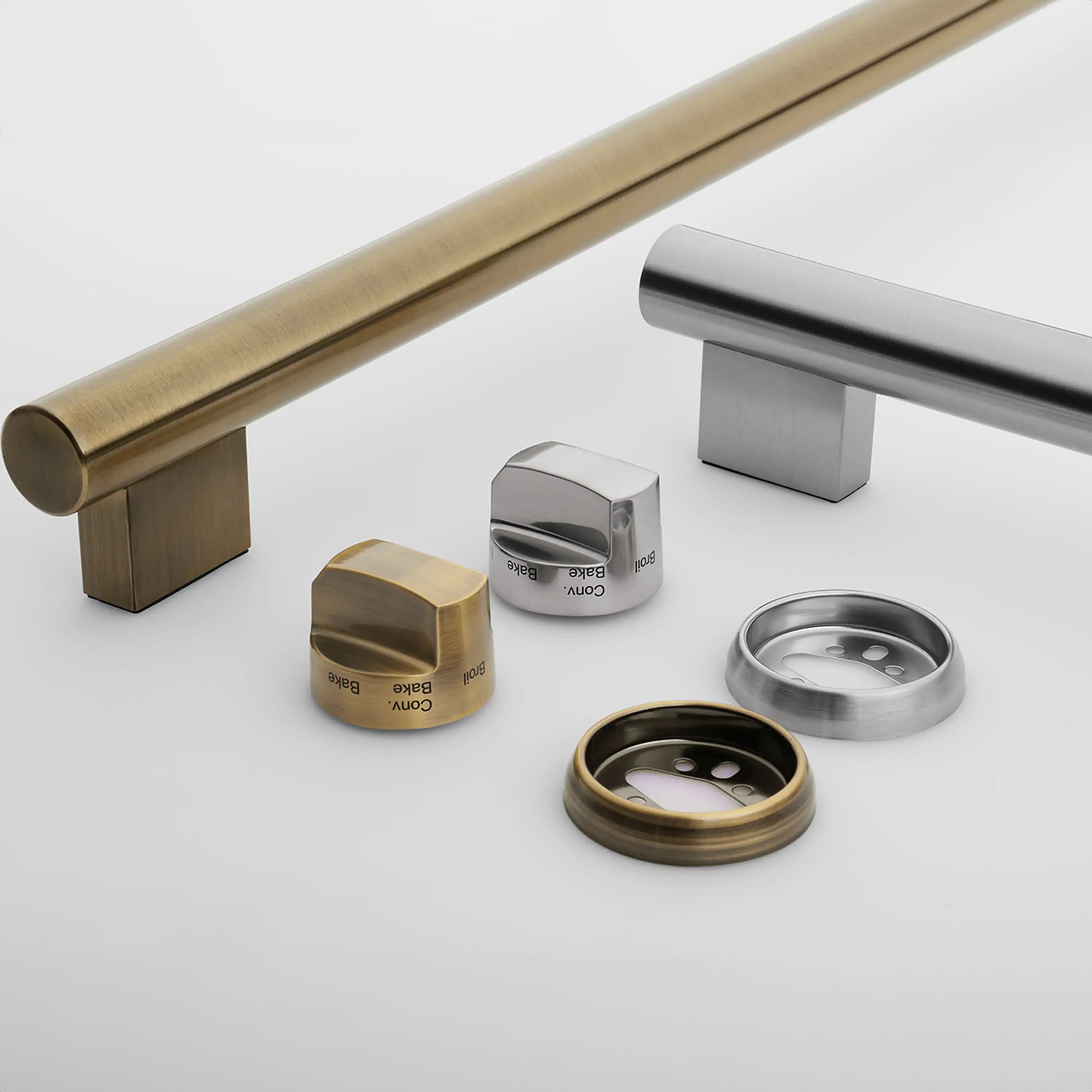 Antique brass trim bar and control knobs on a white induction range