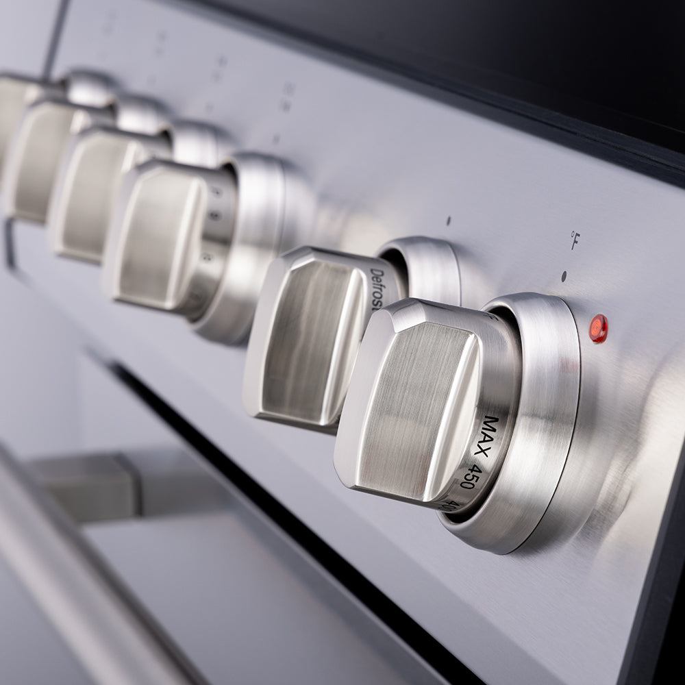 Control knobs and burner area on stainless front panel, labeled indicators visible.