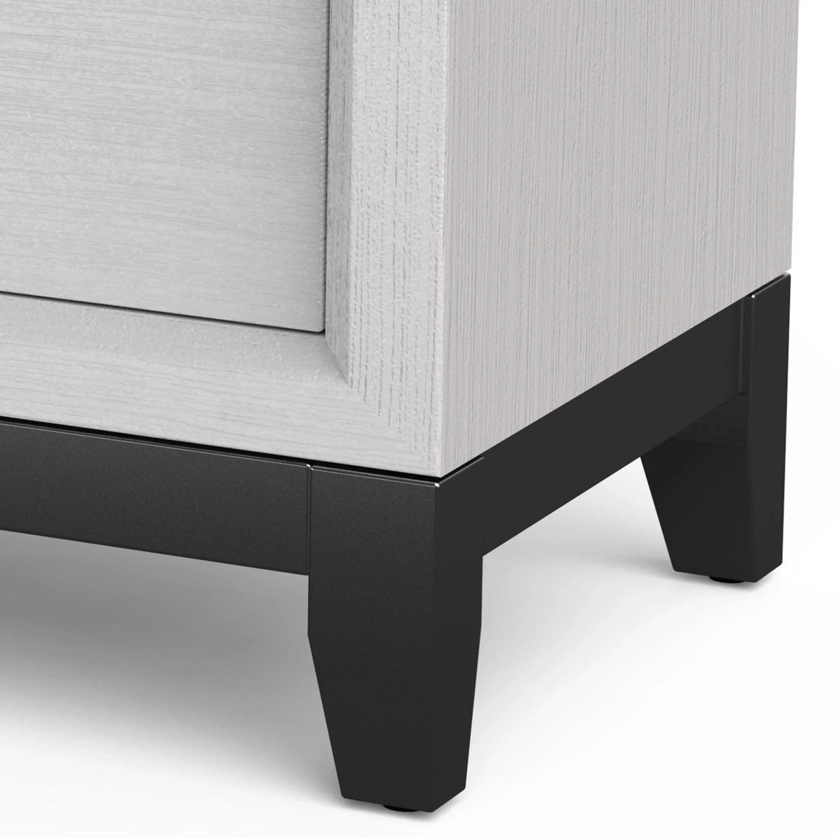 White nightstand corner with two drawers and black tapered legs
