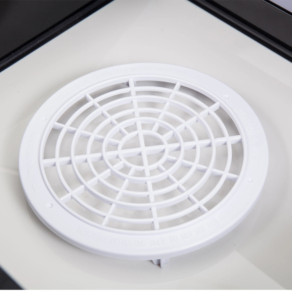 Microwave drawer interior airflow grille with circular fan cover