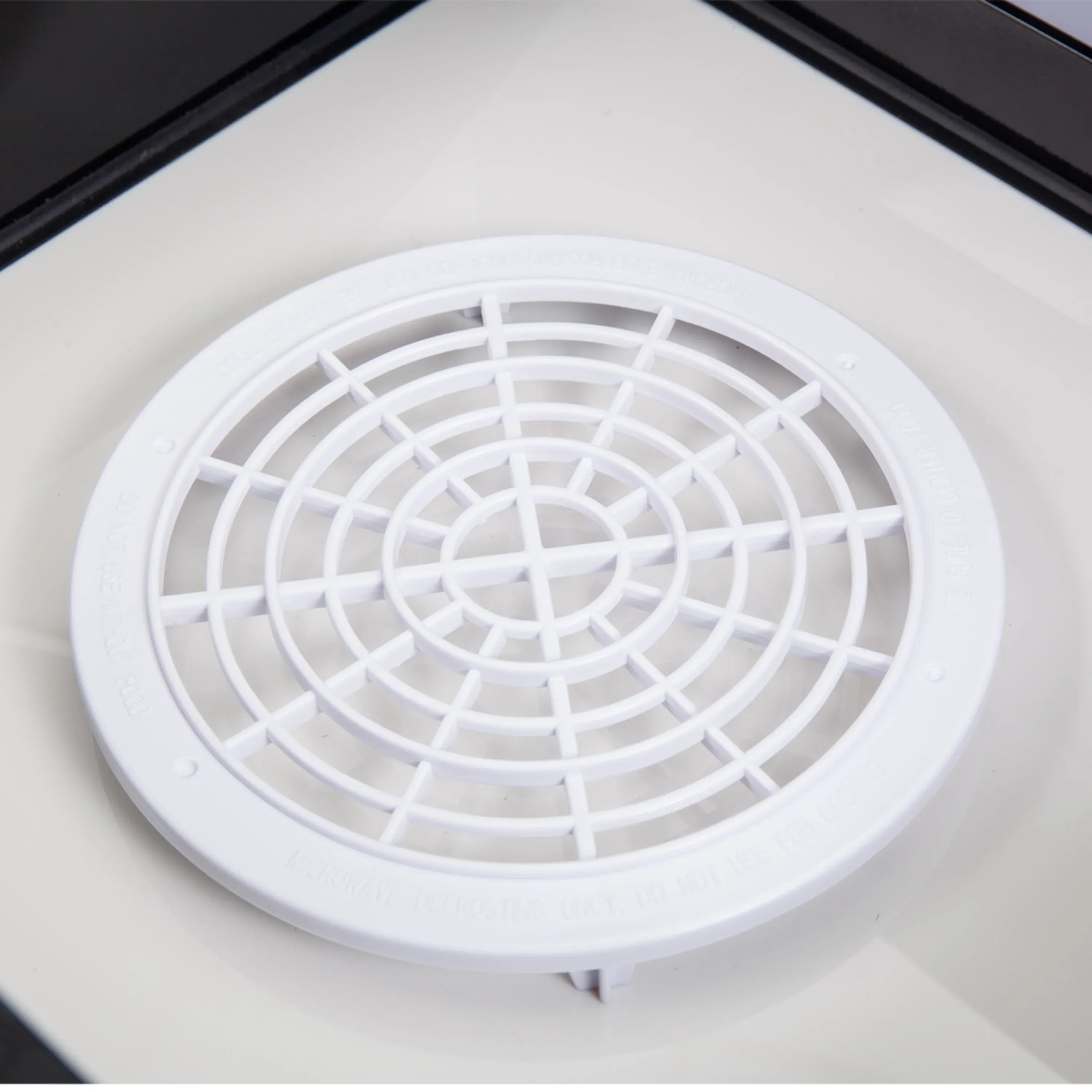 Microwave drawer fan vent with white circular grille