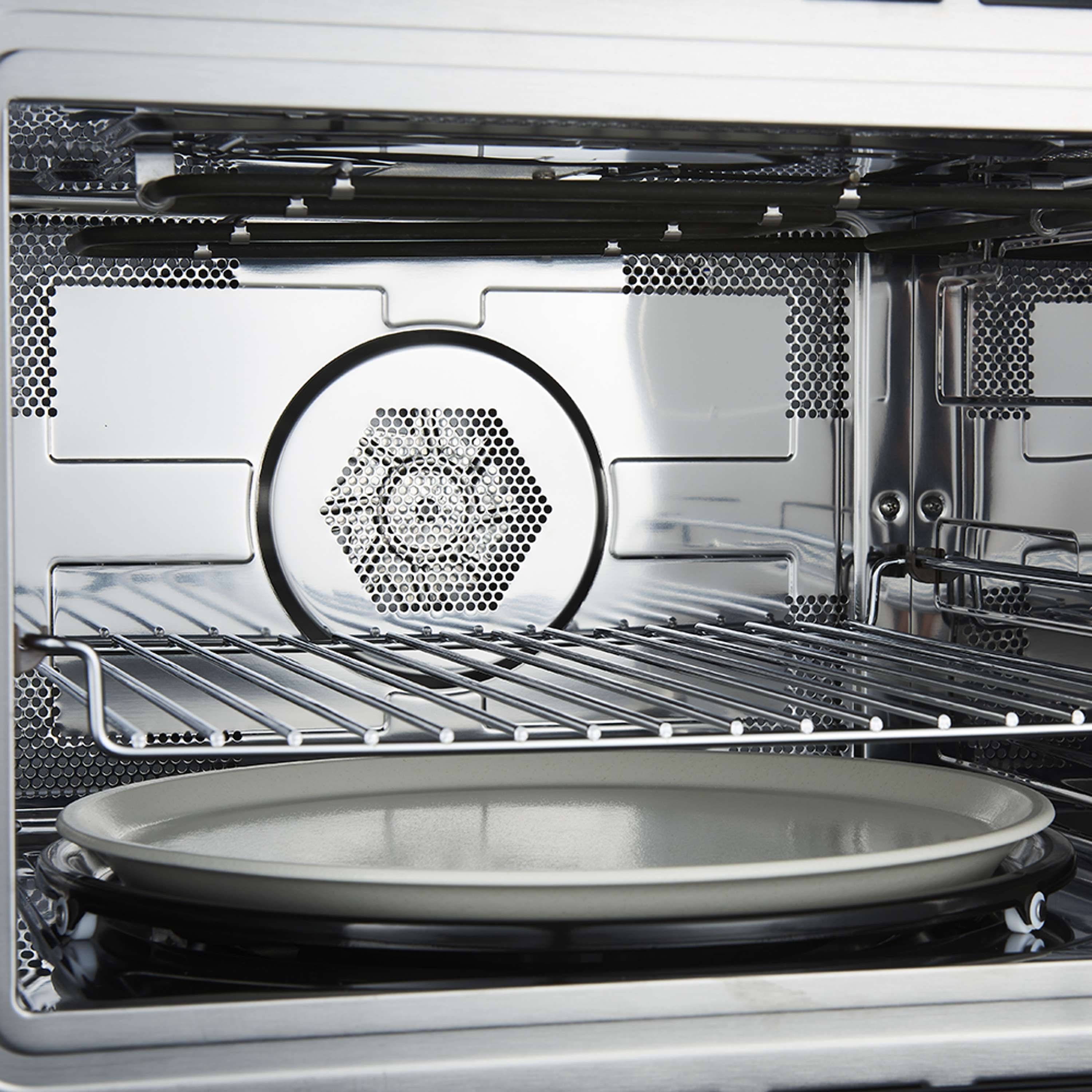 Microwave oven interior with rotating glass turntable and waveguide panel