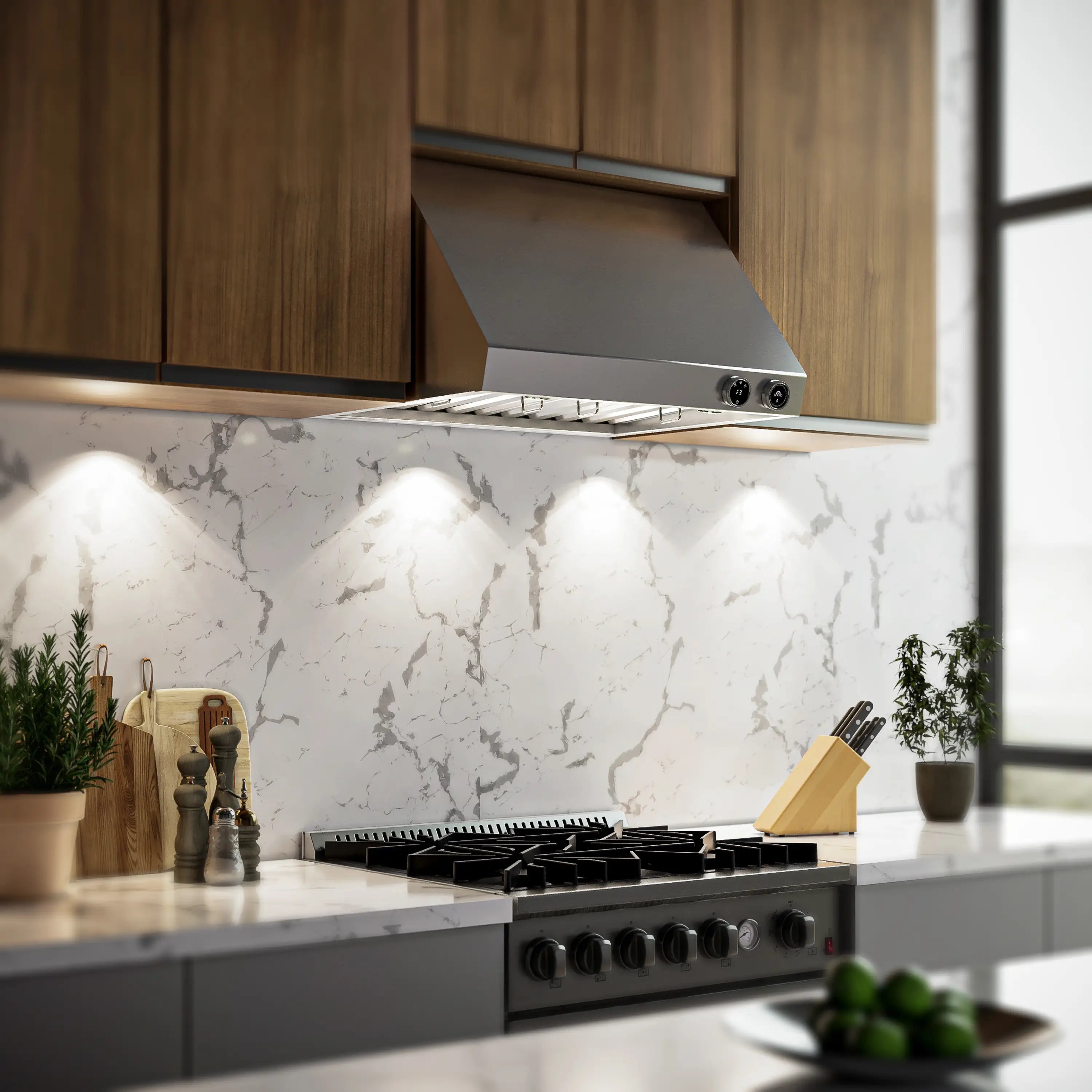 Stainless under-cabinet range hood installed above gas cooktop under cabinet