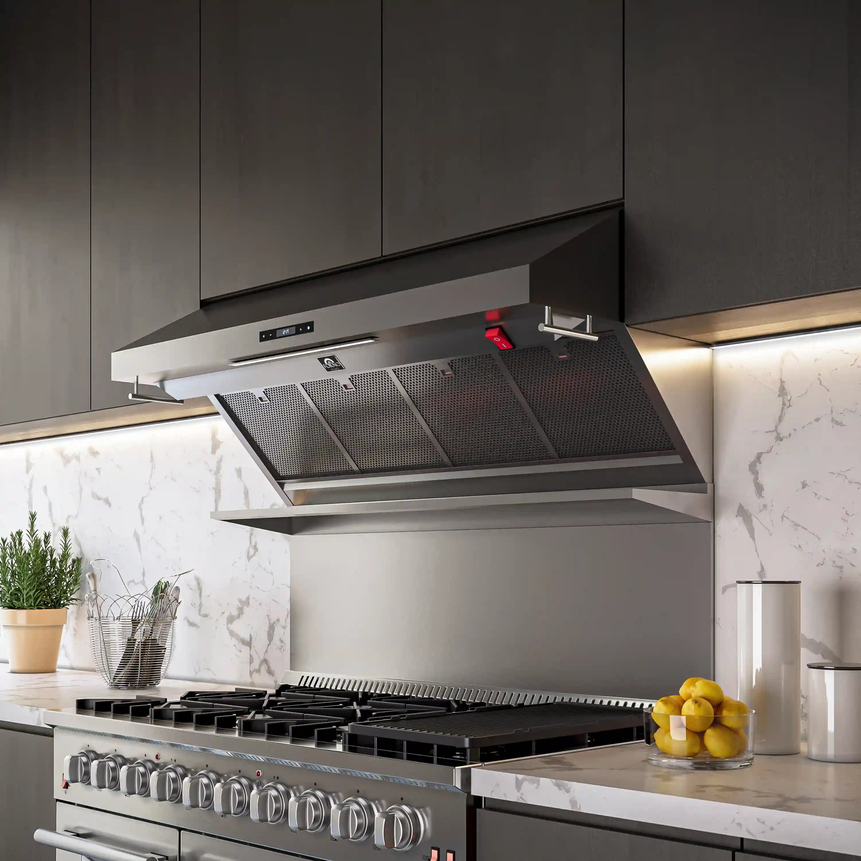 Stainless steel wall mount range hood over cooktop with open filters and red indicator light