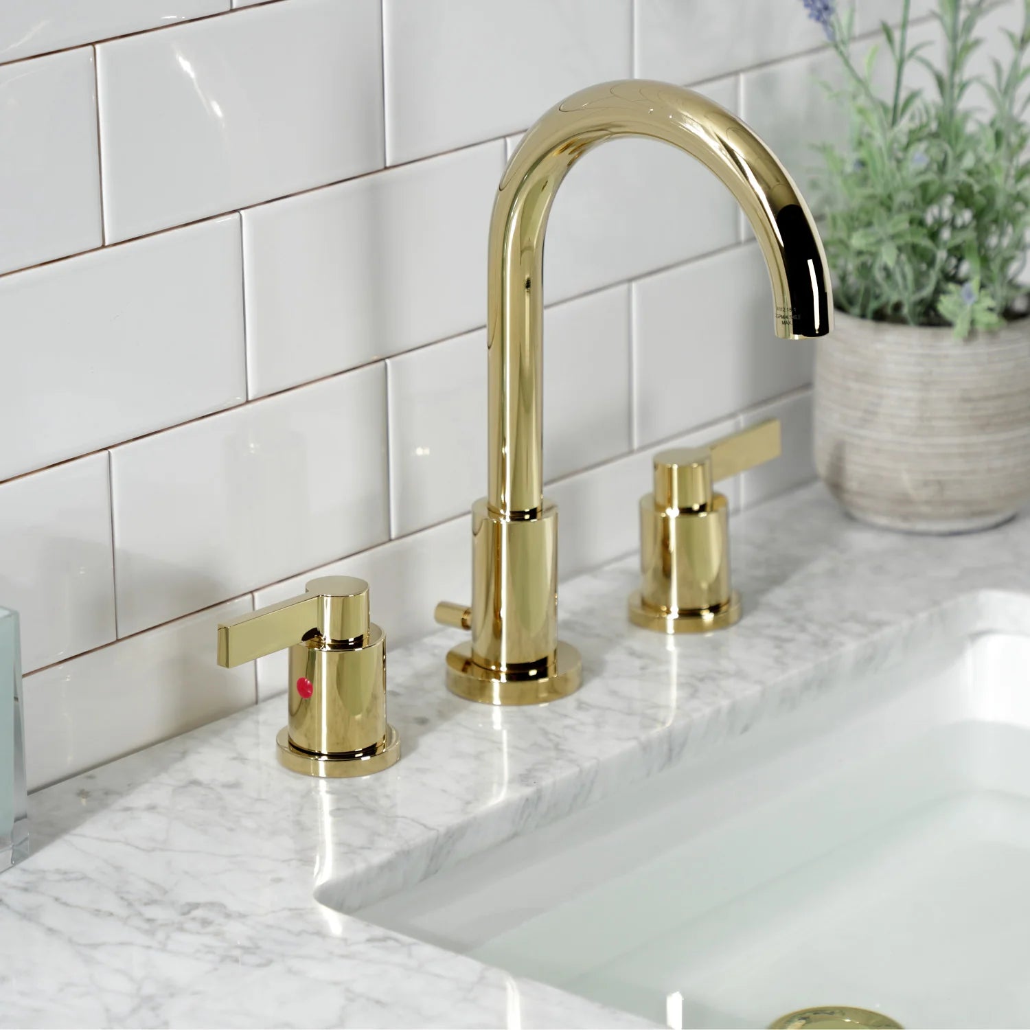 Polished brass widespread bathroom faucet with arched spout and two deck handles