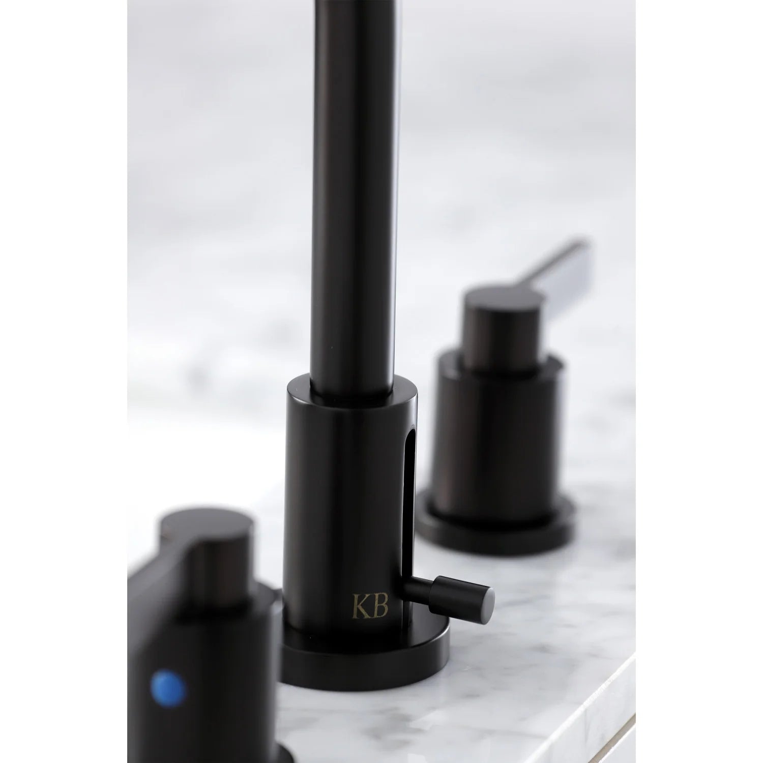 Oil rubbed bronze faucet detail view with tall center spout and side lever handles