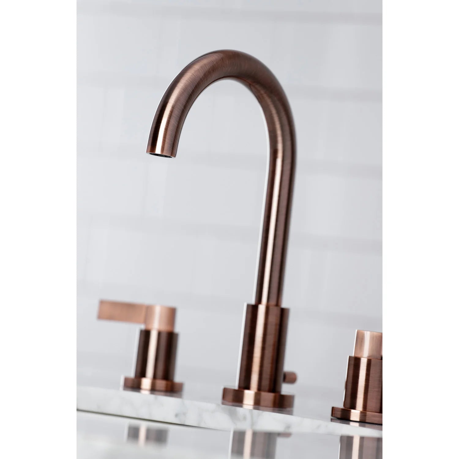 Antique copper widespread bathroom faucet with arched spout and cross-style handles