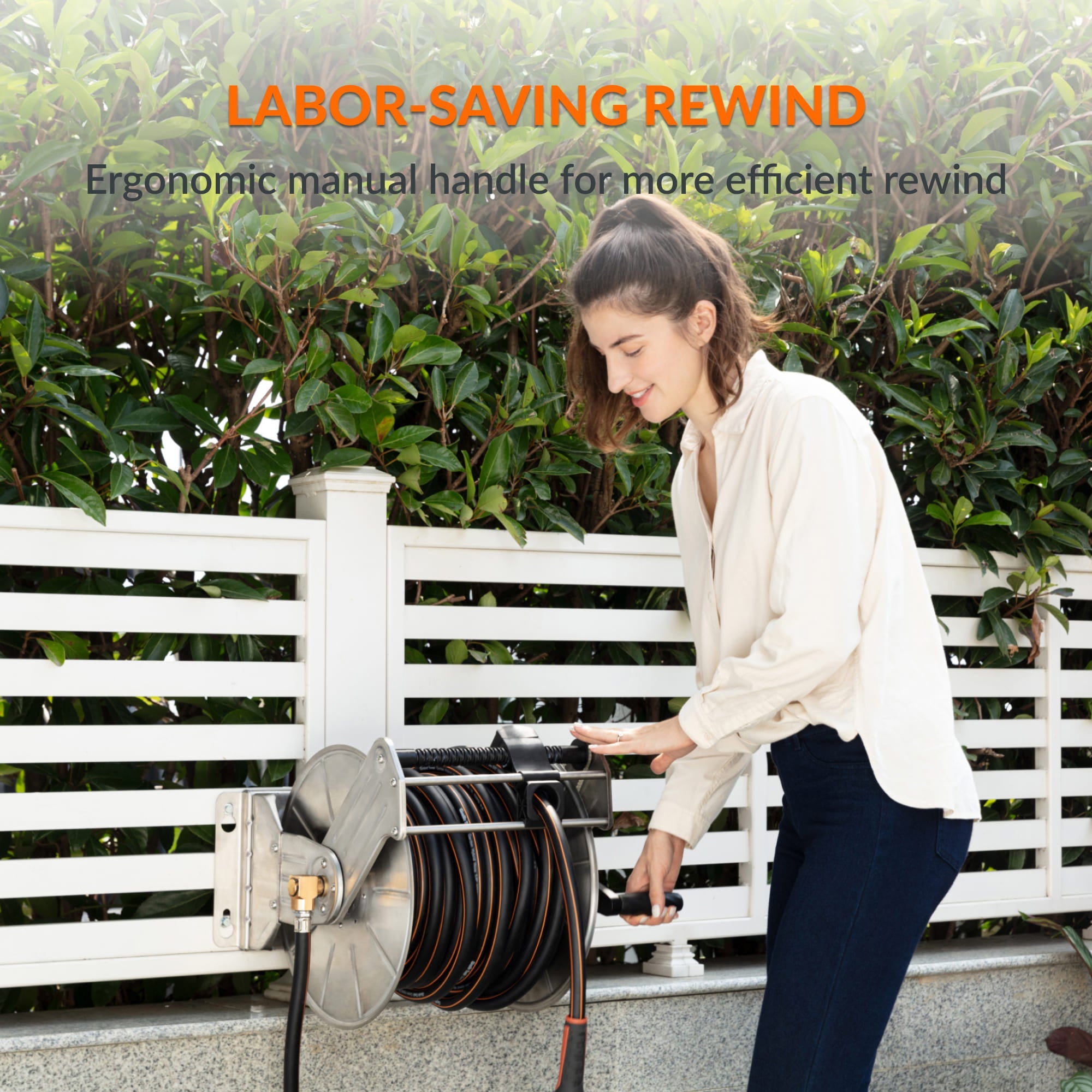 Wall-mounted hose reel with manual rewind handle and neatly coiled hose