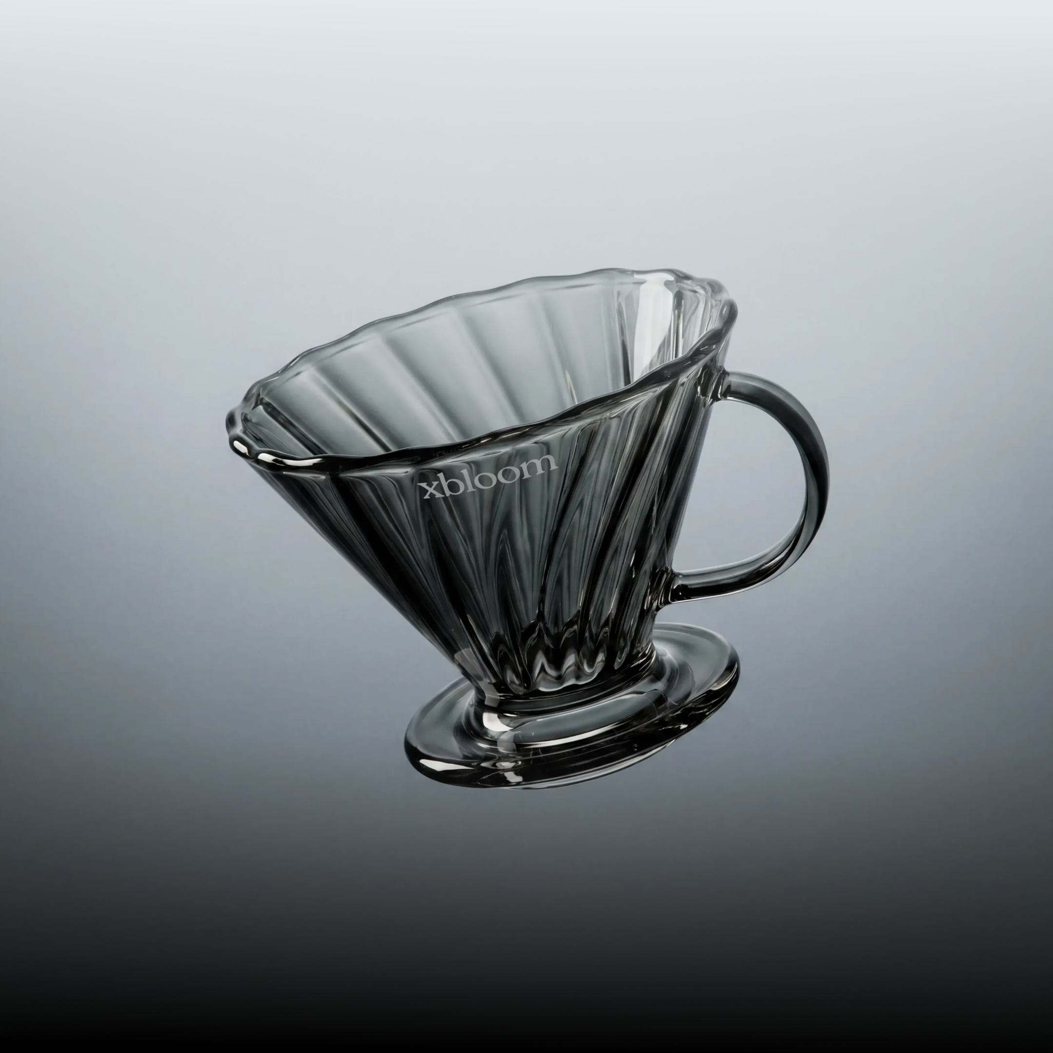 xBloom Infinity conical coffee dripper, angled view, black glass and curved handle
