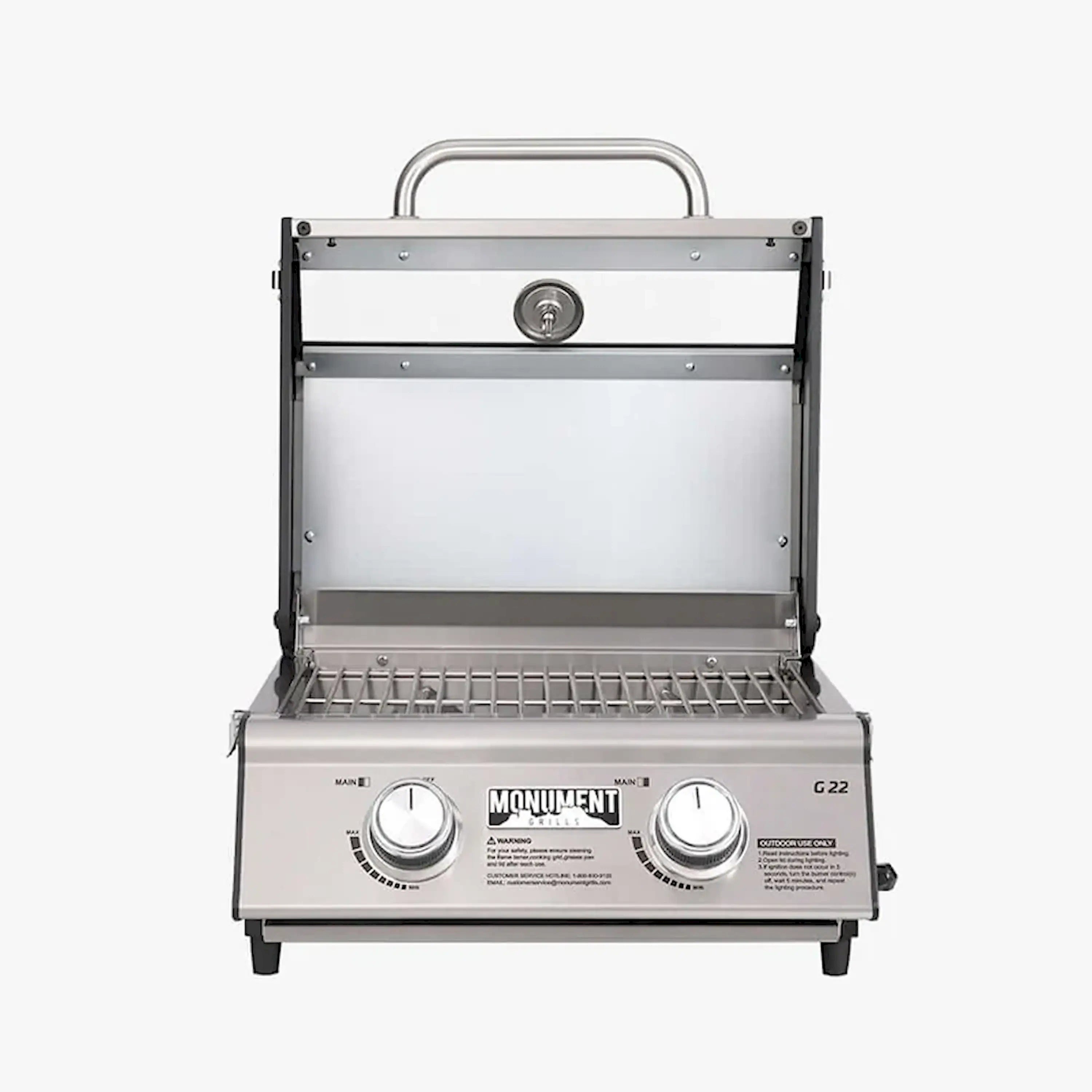 Open-lid Monument G22 tabletop propane gas grill with warming rack and burners