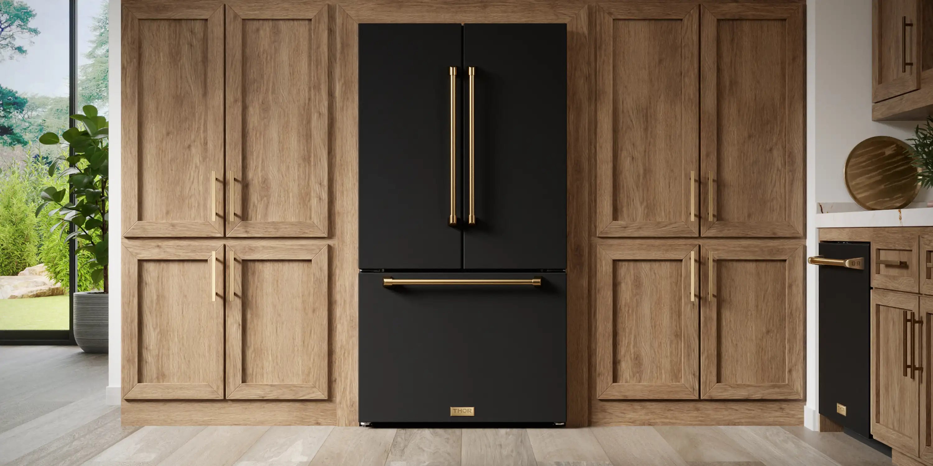 Black refrigerator with gold handle accents and Thor logo door badge