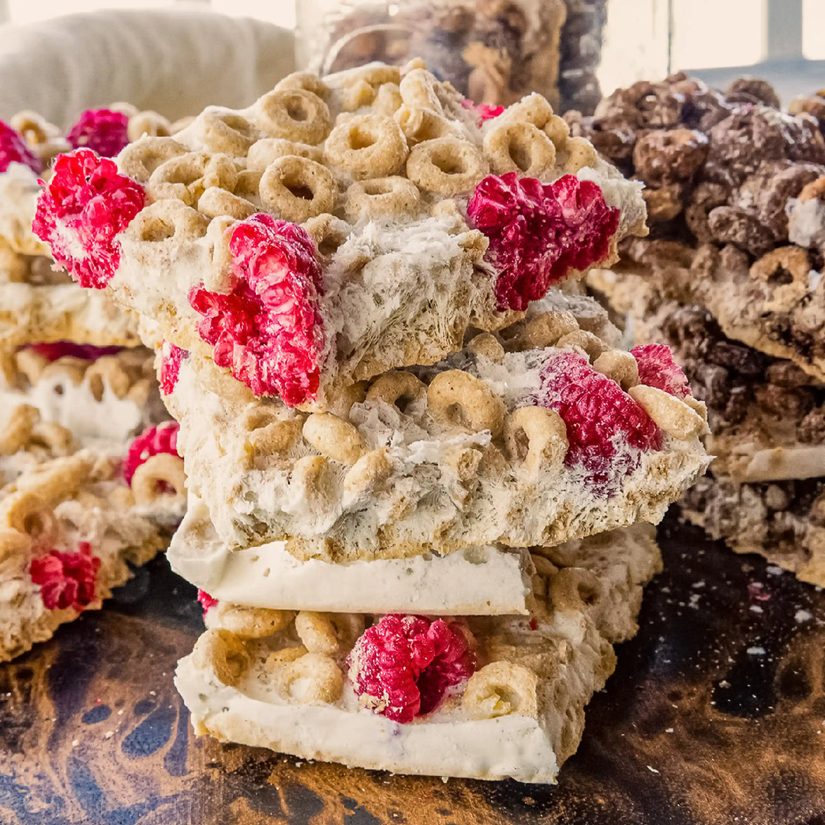 Freeze-dried snack pieces stacked with raspberries
