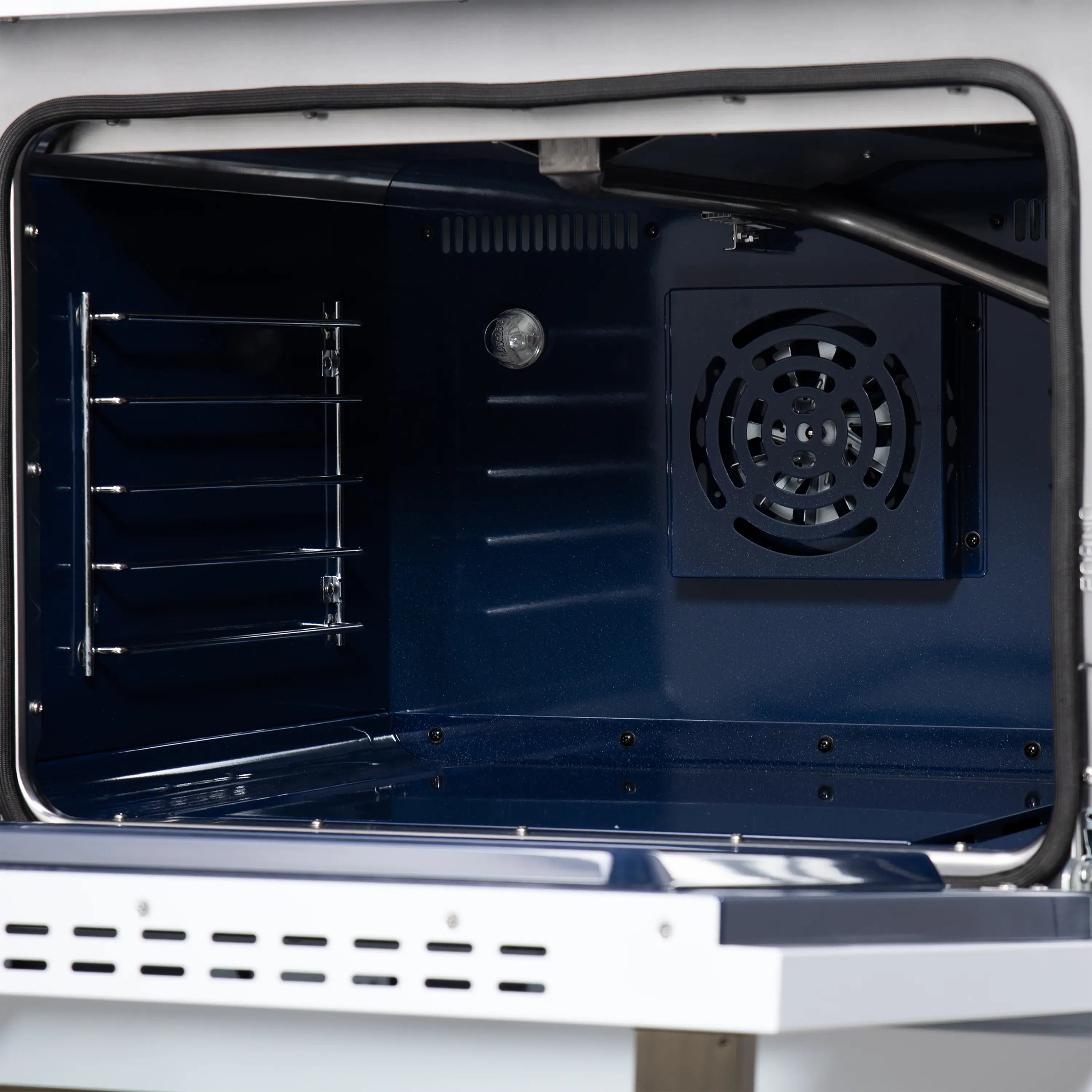 Convection oven rear interior with burner chamber and black cooling fan vent.