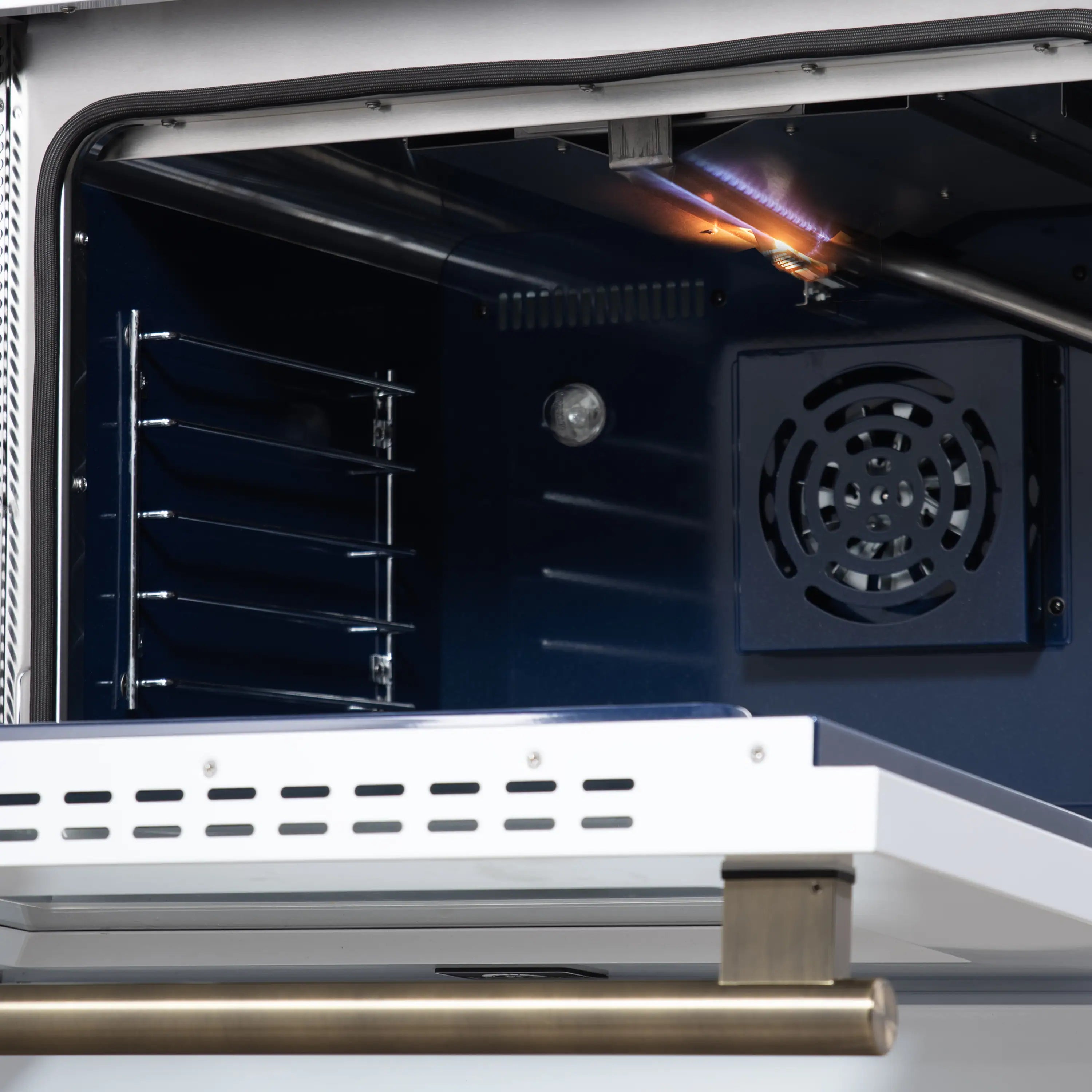 Convection oven interior with heating element glow and fan vent.
