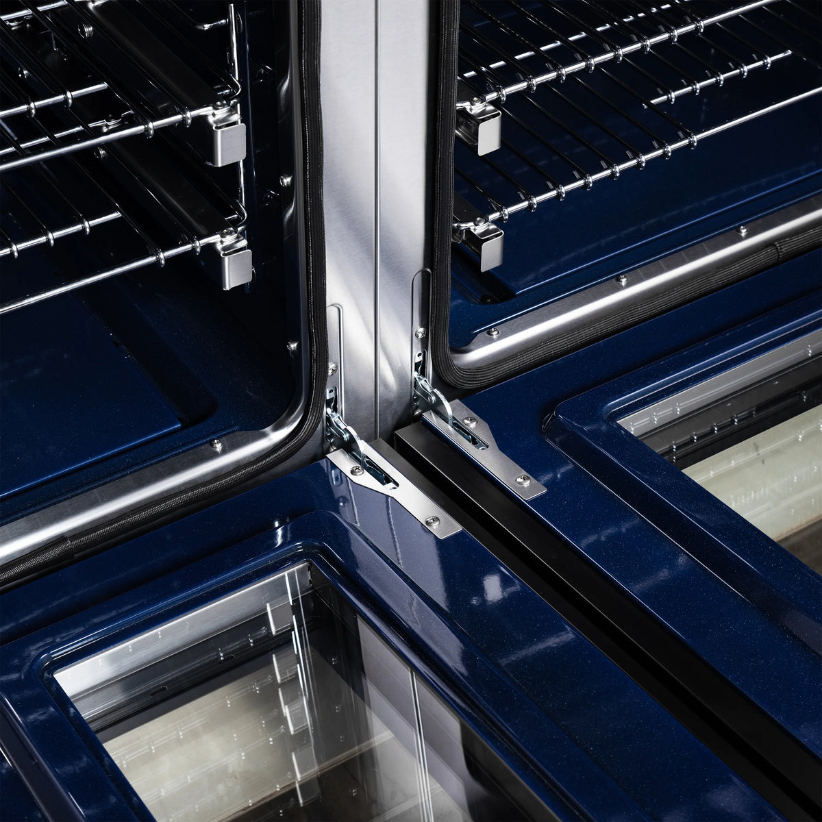 Gas range oven interior with wire racks, blue enamel tray, and side rails