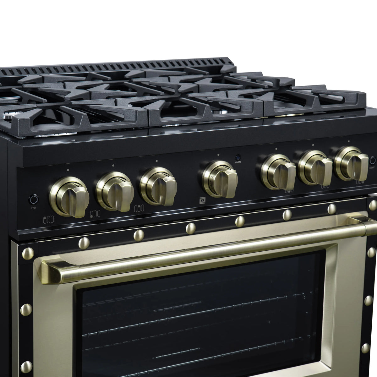 Close-up of black gas cooktop with brass knobs and antique-style brass oven handle.