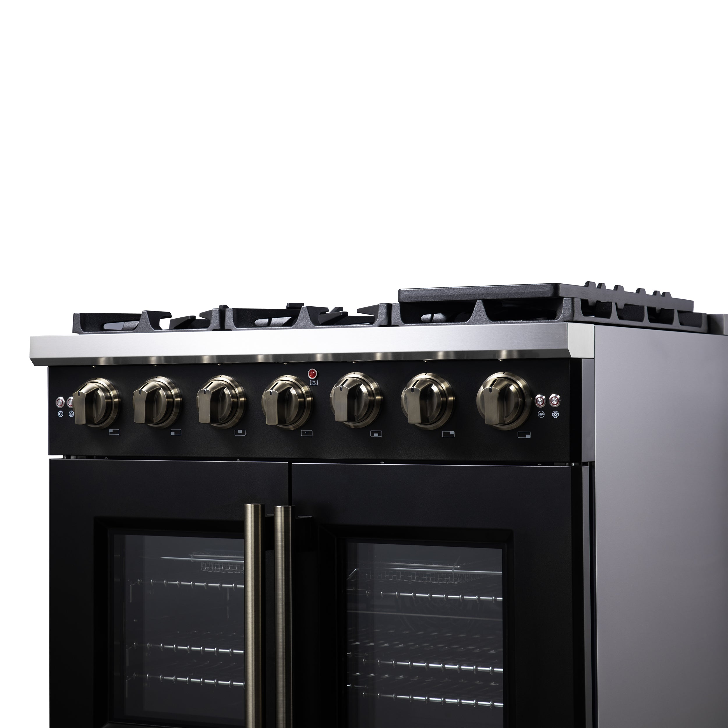Control panel of black gas range with brass knobs and red indicator light