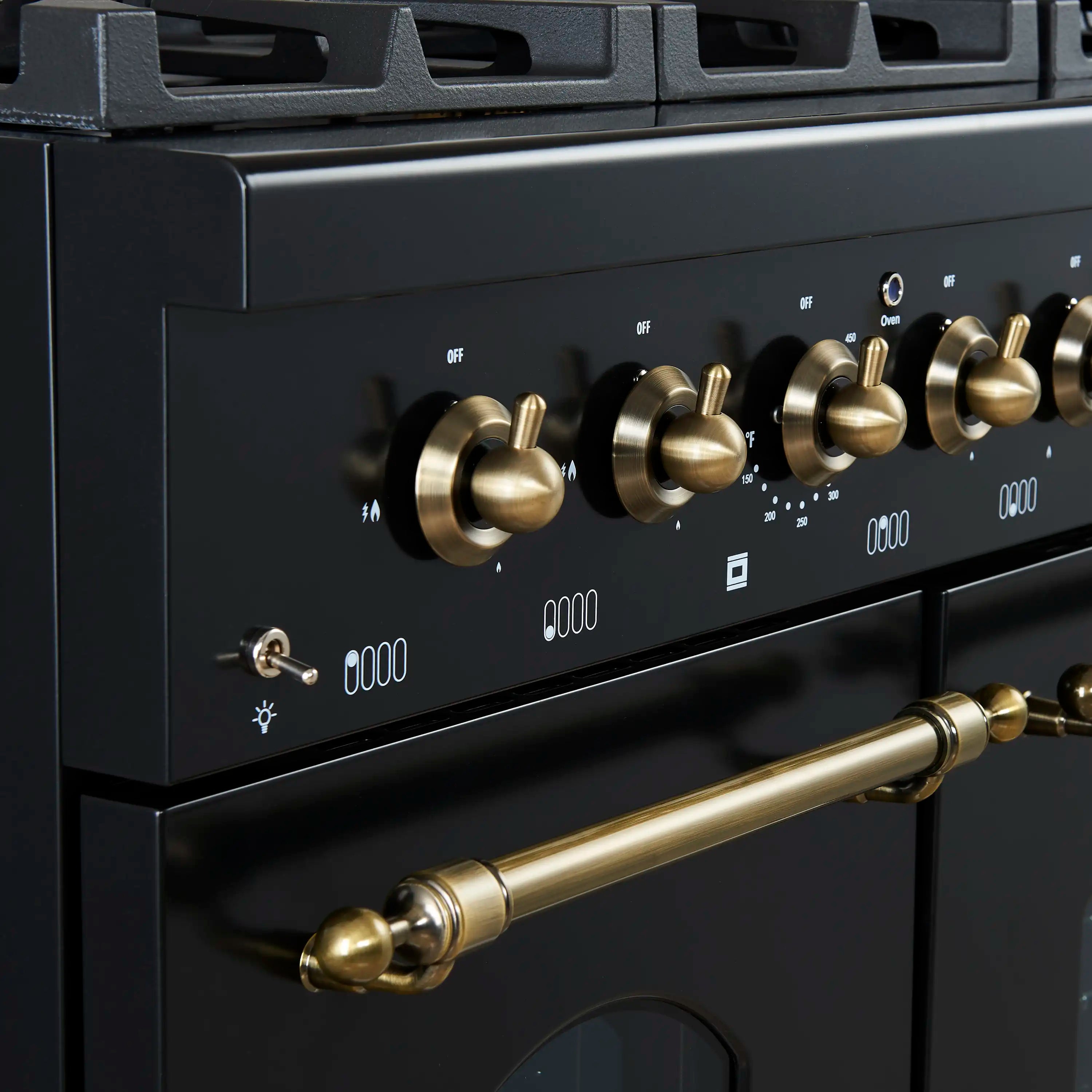 Gas range control panel with antique brass knobs and burner setting icons