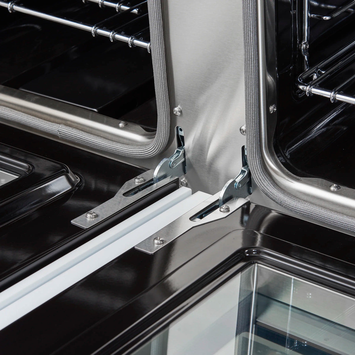 Convection oven interior with stainless baffle, racks, and gas burner area.
