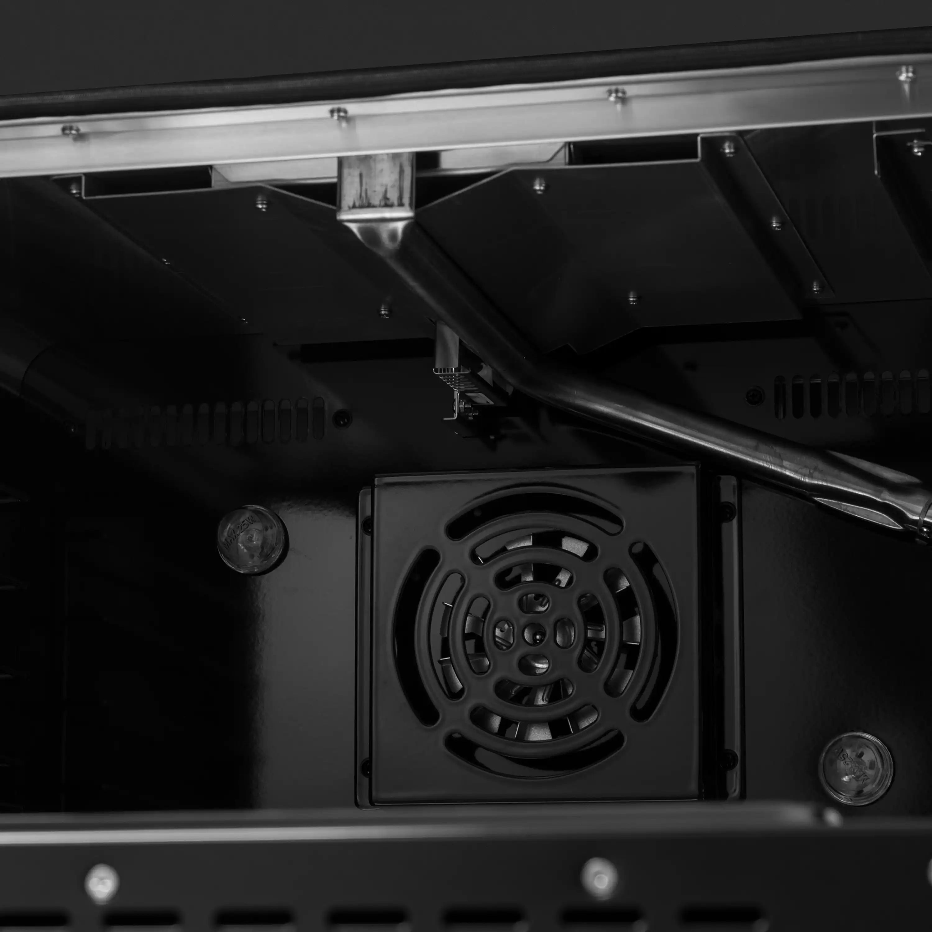 Black oven cavity with circular blower vent and visible mounting hardware