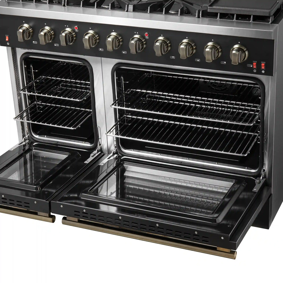 Close view of open black gas range ovens with wire racks and front drawer rails.