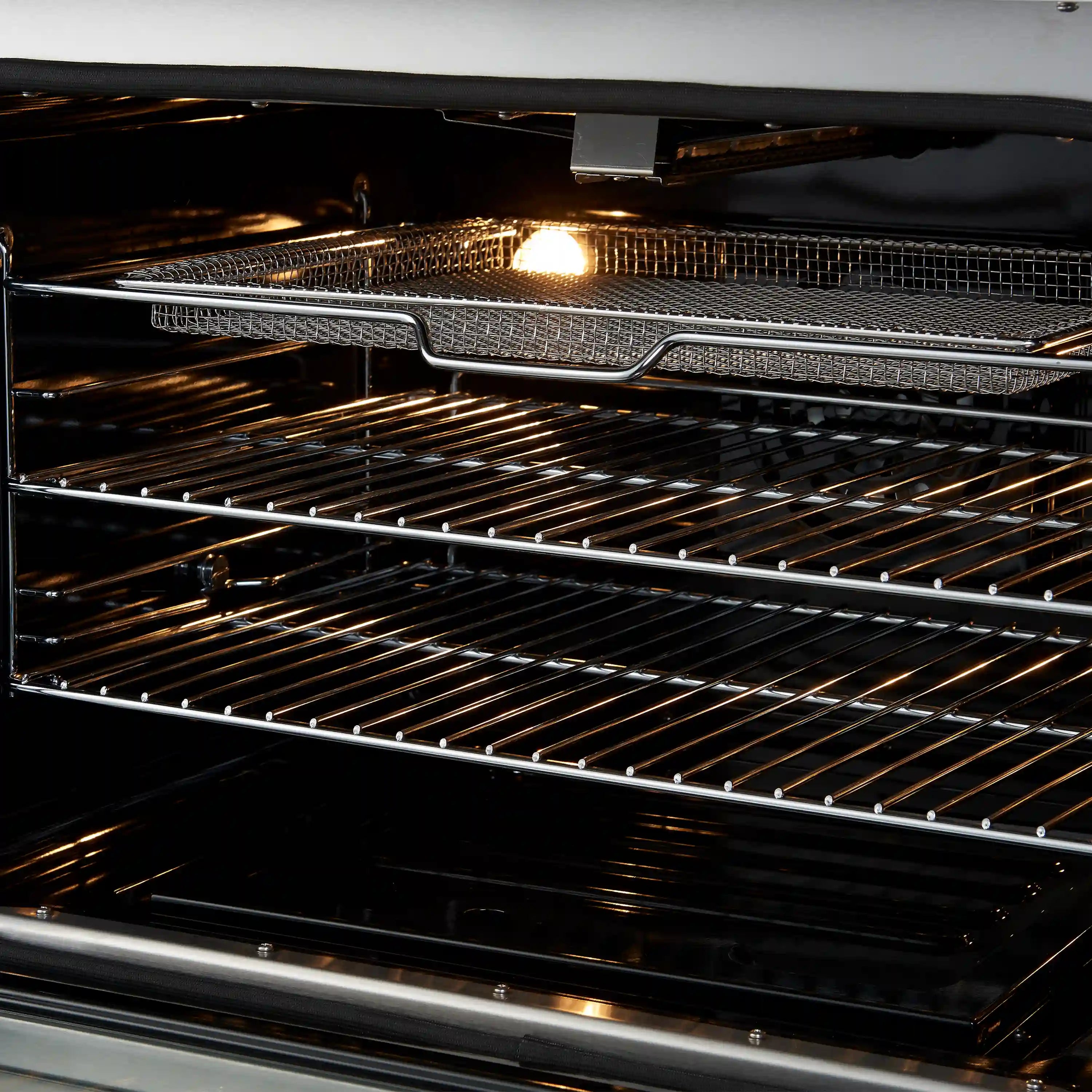 Convection oven interior with metal racks and oven light