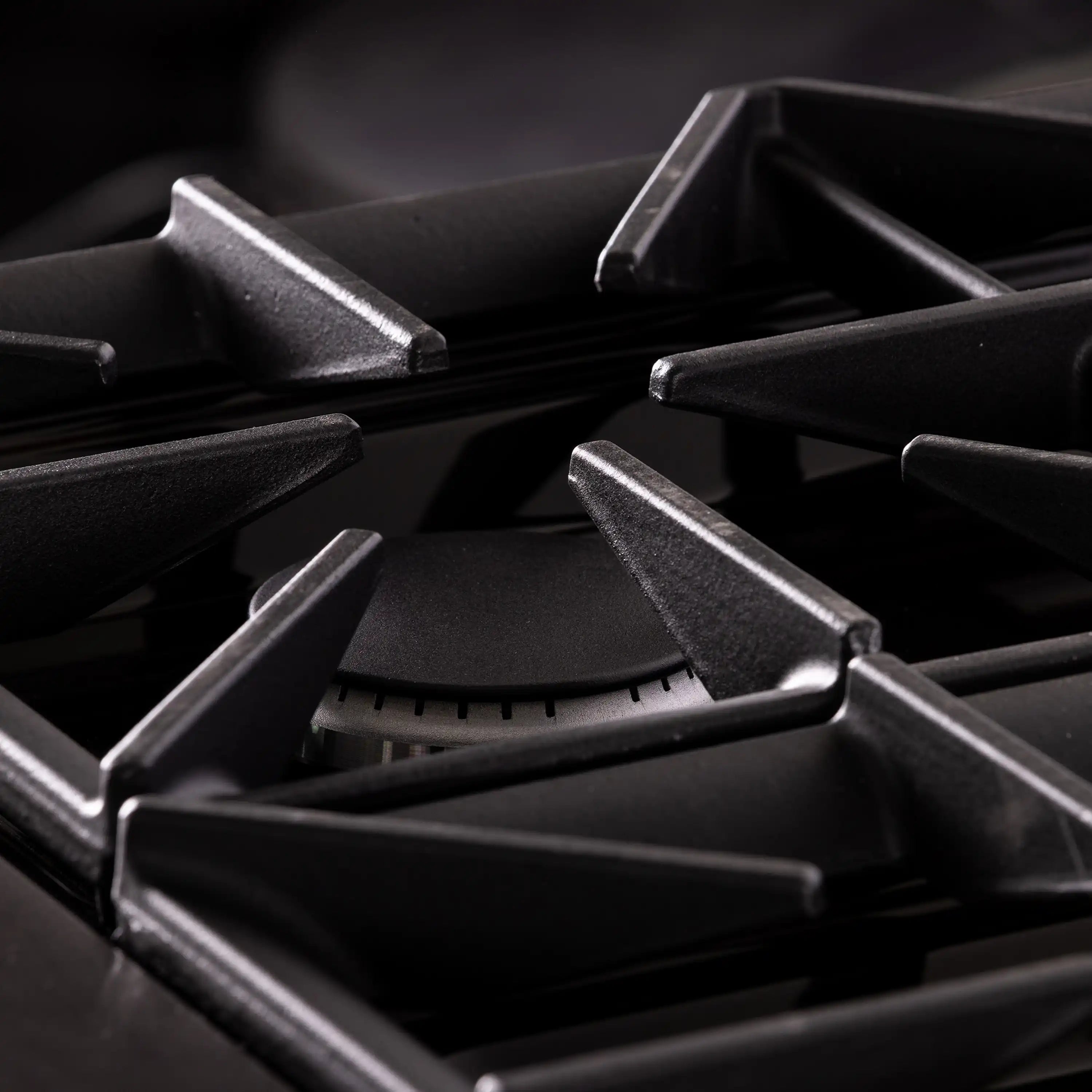 Gas burner caps and dark titanium grate with stainless burner control knobs