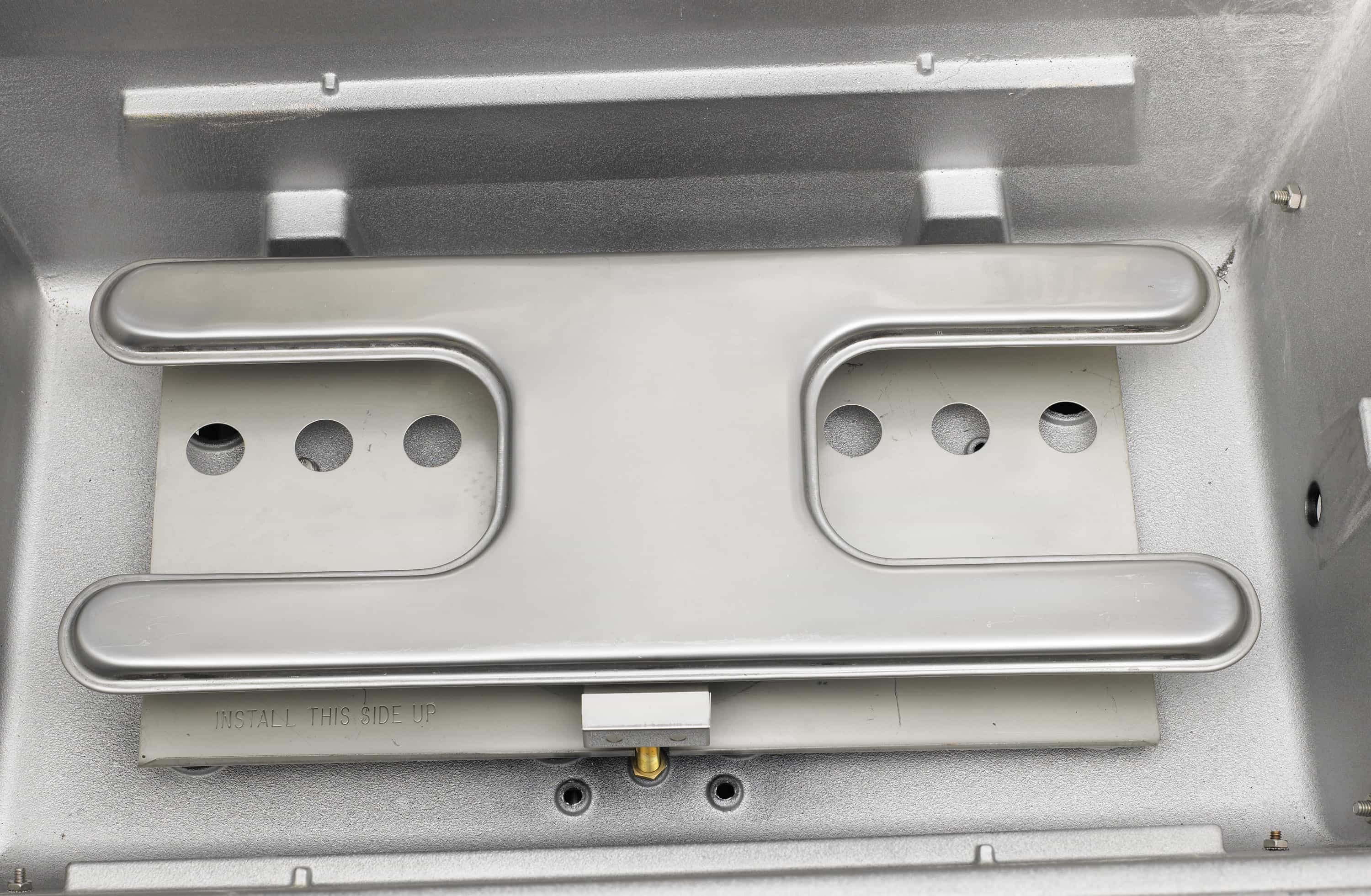 Built-in natural gas grill burner control area with two stainless burner covers