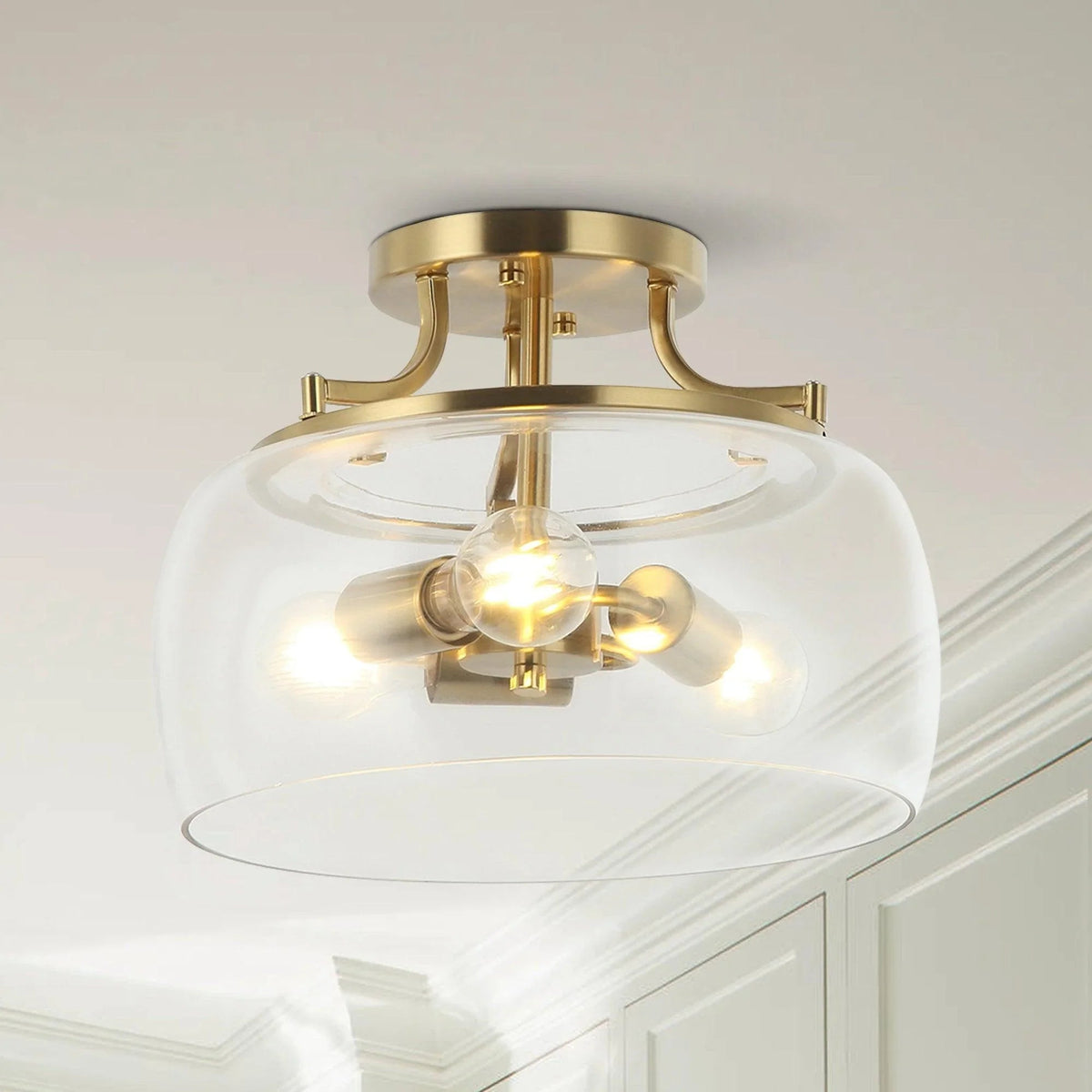 Brass gold semi-flush ceiling light with clear 3-light glass shade and exposed bulbs