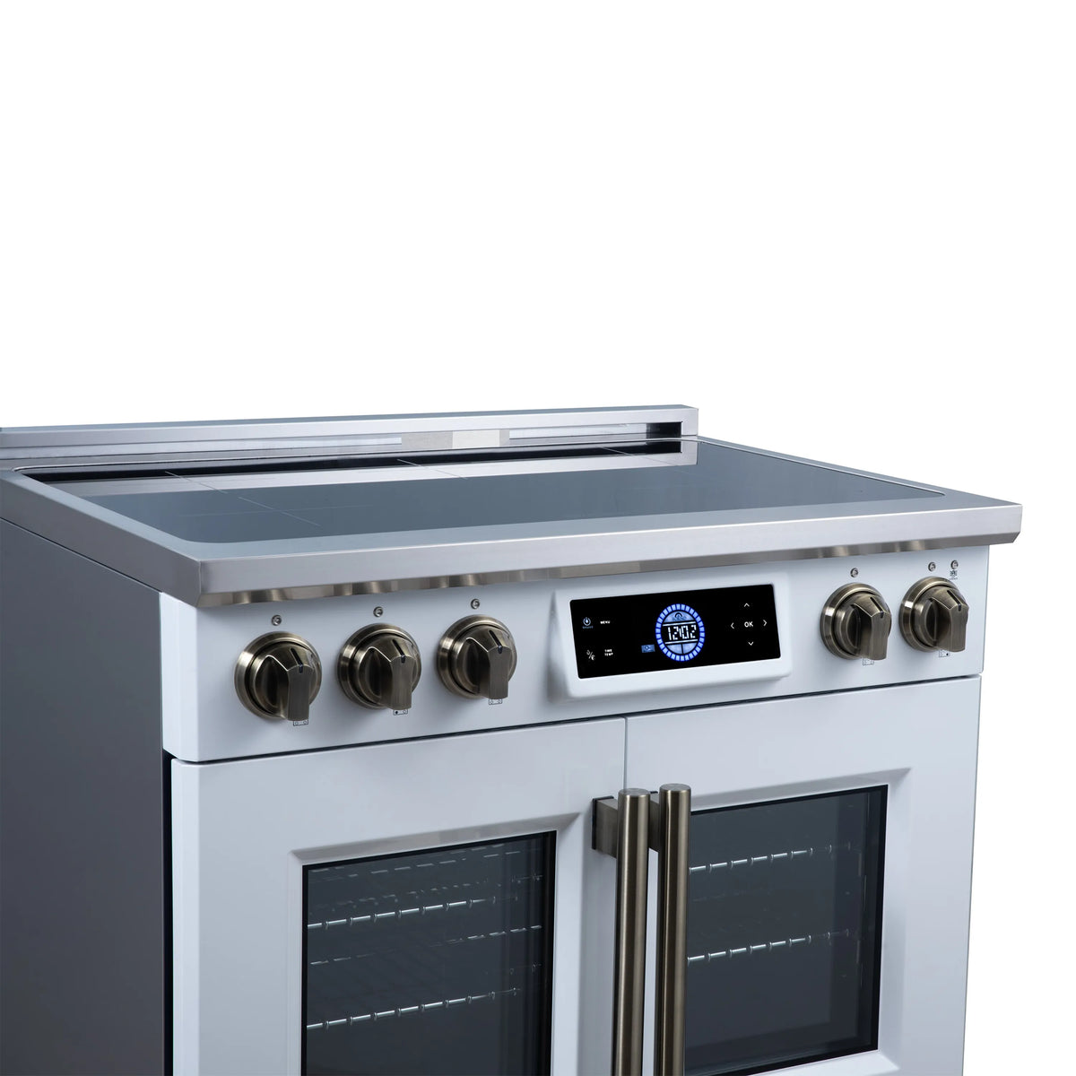 White induction cooktop and control panel on an induction range with brass-finish knobs