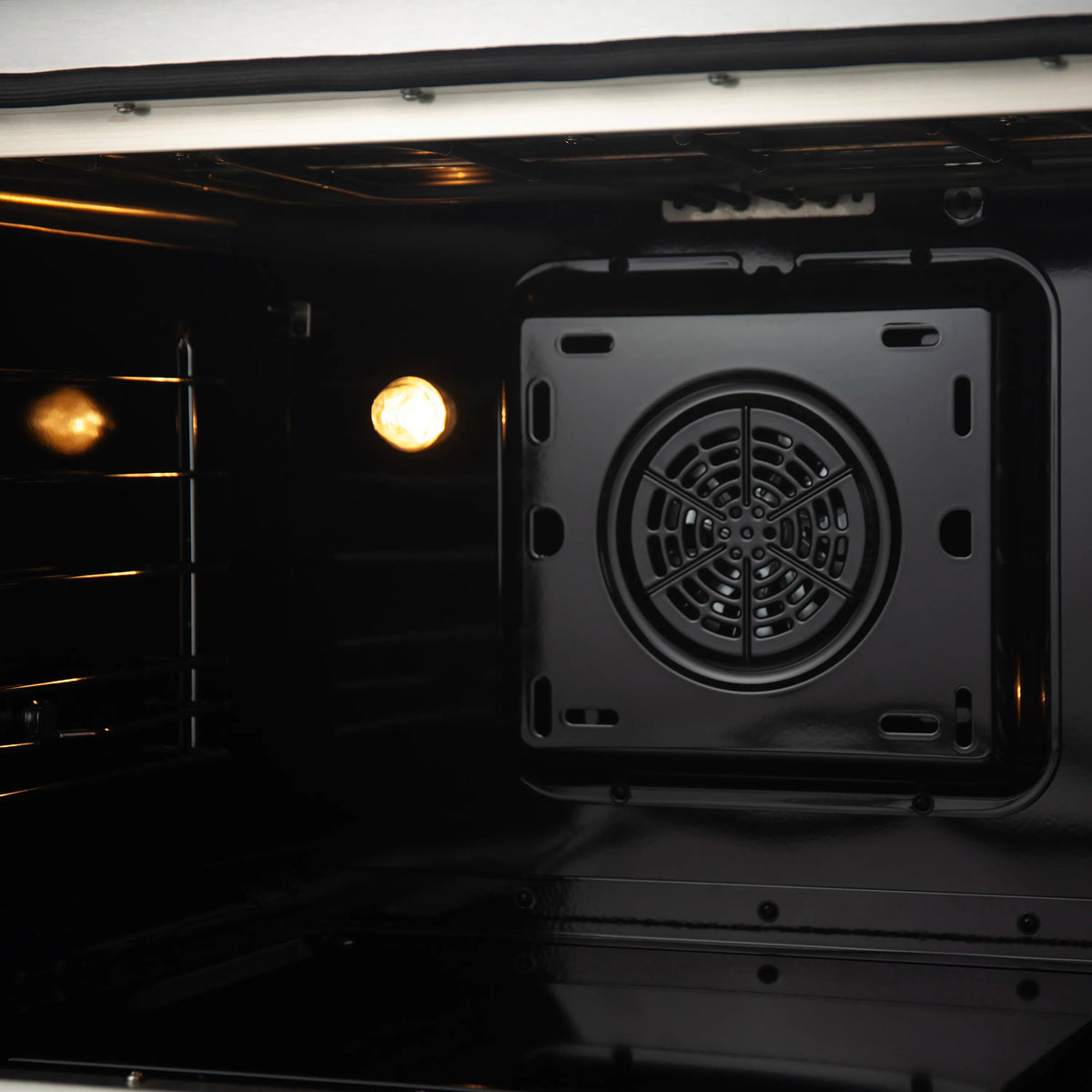 Stainless steel induction oven cavity with circular convection fan vent