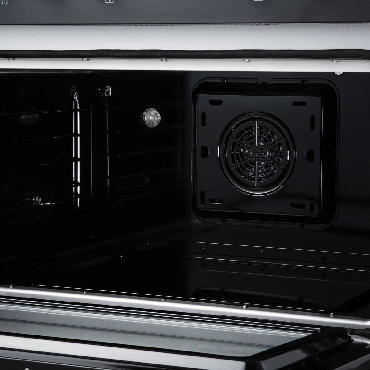 Convection oven interior with fan vent and rack rails, black enamel