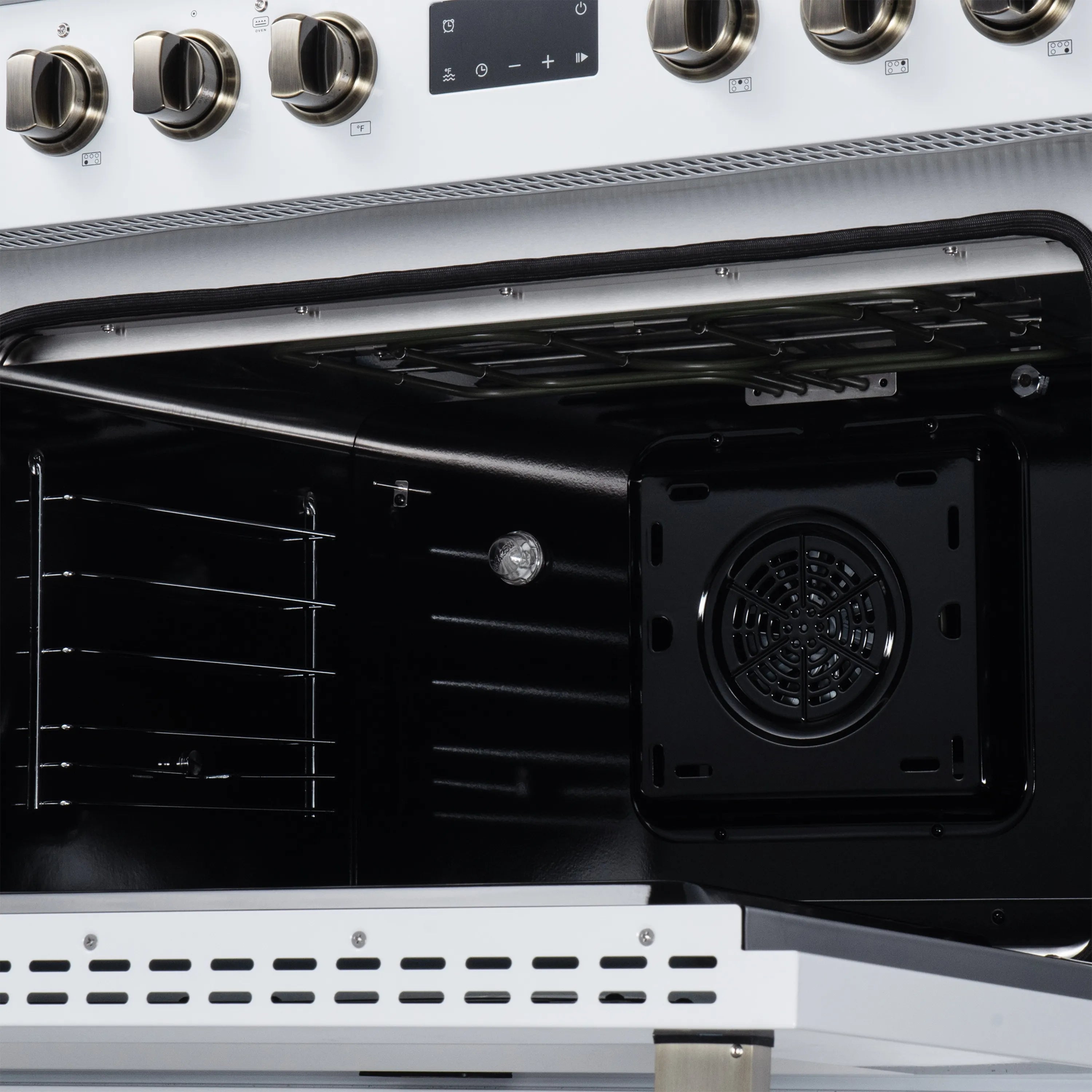Close-up of open oven interior showing rear fan vent and dark racks inside.
