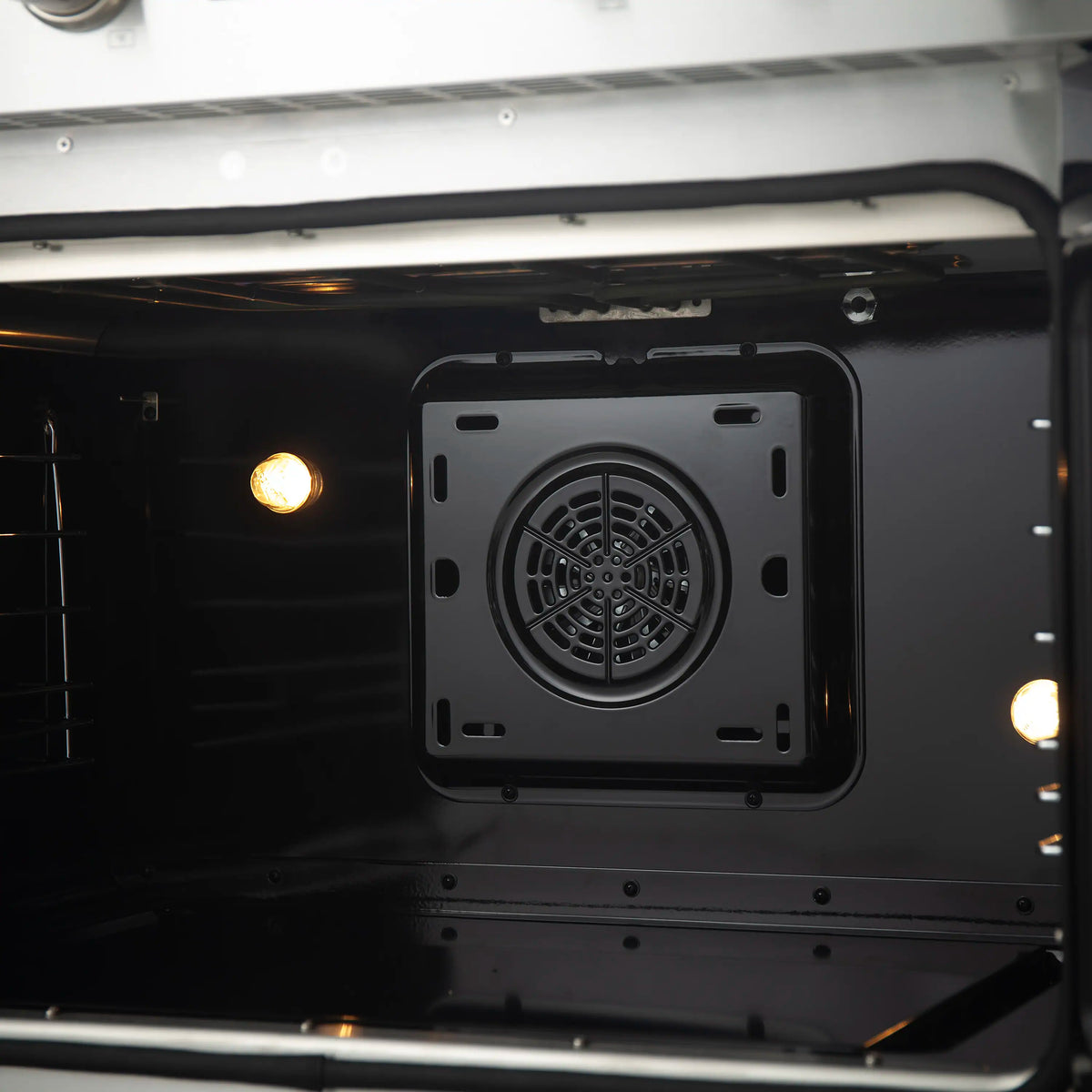 Induction range oven interior with rear convection fan