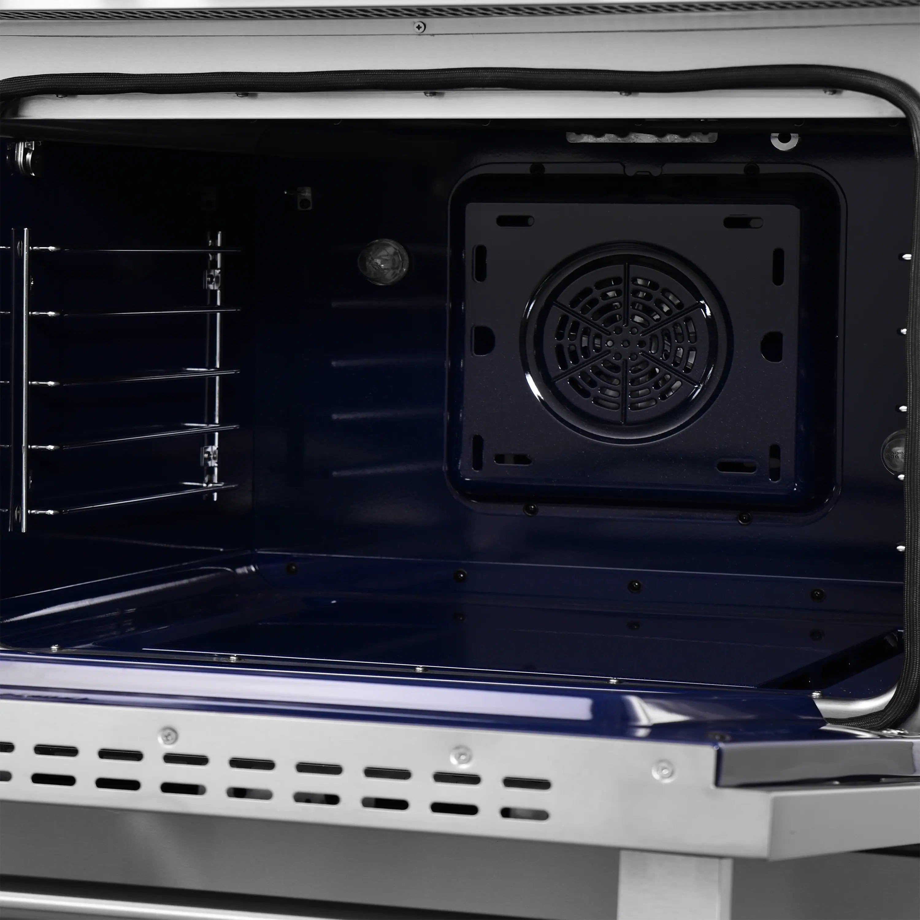 Air fryer oven interior with fan housing and dark metal cooking chamber